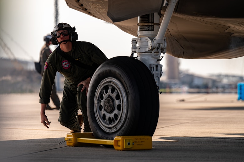 A marine examines an aircraft