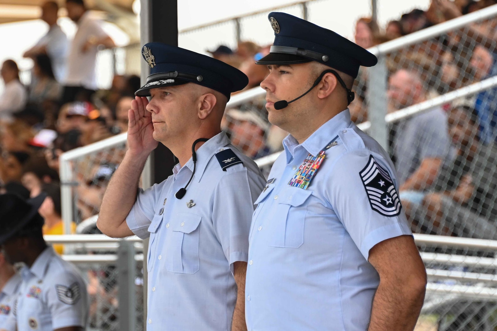 U.S. Air Force Col. Jeff Marshall, 97th Air Mobility Wing (AMW) commander, salutes graduating Airmen, while Chief Master Sgt. Justin Brundage, 97th AMW command chief, stands at attention, during the Basic Military Training graduation pass in review at Joint Base San Antonio-Lackland, Texas, May 16, 2024. Marshall served as the reviewing official for the graduation parade. (U.S. Air Force photo by Senior Airman Kari Degraffenreed)