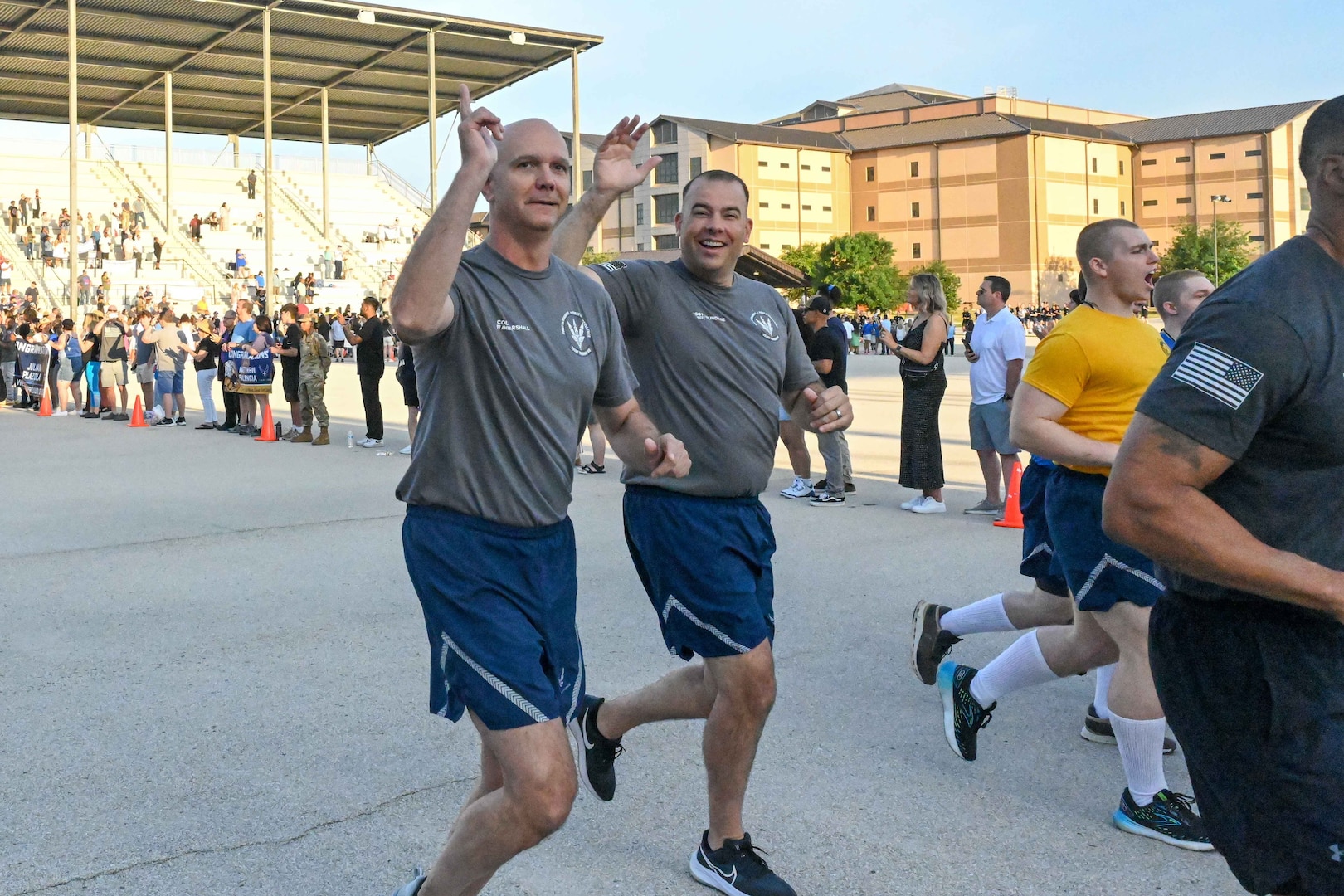 U.S. Air Force Col. Jeff Marshall, 97th Air Mobility Wing (AMW) commander, and Chief Master Sgt. Justin Brundage, 97th AMW command chief, join the 321st Training Squadron for the Airman’s Run during a Basic Military Training (BMT) graduation at Joint Base San Antonio-Lackland, Texas, May 15, 2024. The one-and-a-half mile run is the first opportunity for graduating Airmen to see their loved ones after leaving for BMT seven-and-a-half weeks prior. (U.S. Air Force photo by Senior Airman Kari Degraffenreed)
