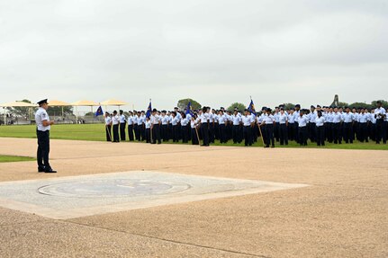 U.S. Air Force Chief Master Sgt. Justin Brundage, 97th Air Mobility Wing command chief, addresses graduating Airmen during the Air Force Basic Military Training (BMT) graduation at Joint Base San Antonio-Lackland, Texas, May 16, 2024. Brundage congratulated and encouraged the 494 graduating Airmen on their last official day of BMT. (U.S. Air Force photo by Senior Airman Kari Degraffenreed)