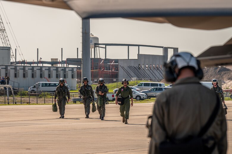 Marines walk on the flight line