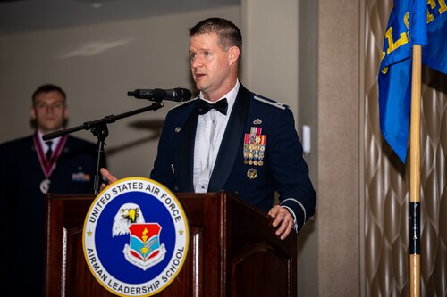 Col. Richards stands behind a podium giving a speech