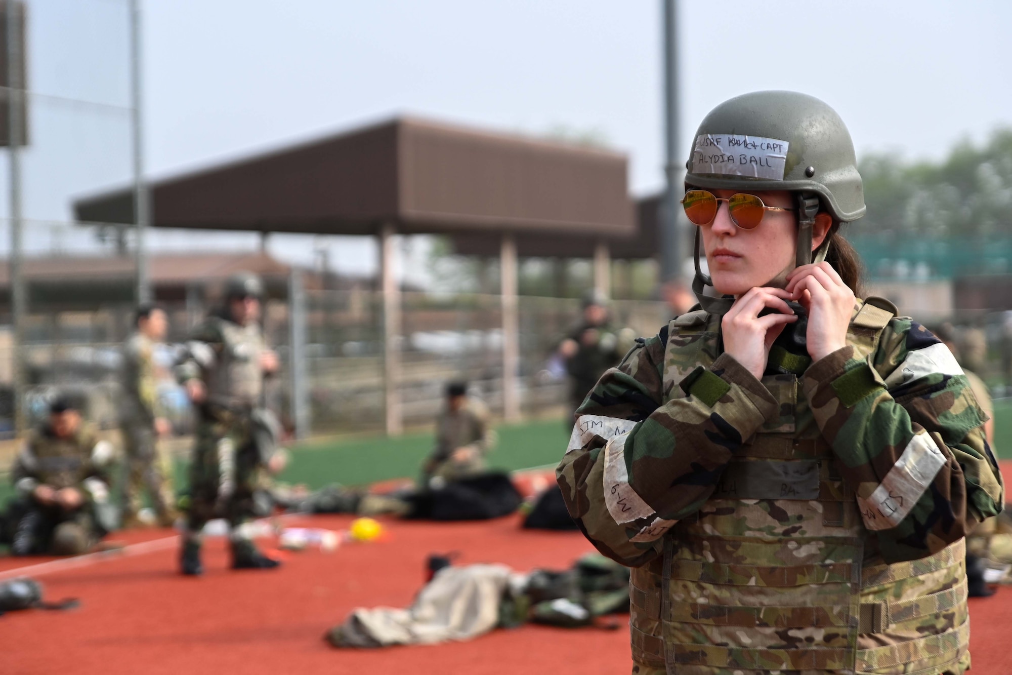 Capt Alydia Ball, 694th ISRG CCQ section commander, adjusts her helmet during chemical, biological, radiological, and nuclear gear during an Ability to Survive and Operate rodeo at Osan Air Base, Republic of Korea, April 26, 2024.