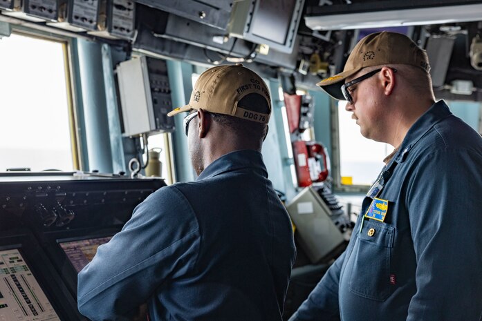SHIMODA, Japan (May 20, 2024) Cmdr. Ron Jenkins from Columbia, South Carolina, (left) and Cmdr. Steve Terjesen from Peekskill, New York, (right) oversee a sea and anchor evolution from the pilothouse of the Arleigh Burke-class guided-missile destroyer USS Higgins (DDG 76) while departing after a scheduled port visit to the 85th Black Ship Festival in Shimoda, Japan, May 20. The Black Ship Festival commemorates the 171st anniversary of the arrival of Commodore Matthew Perry in Japan in 1853, a historical event that marked the beginning of diplomacy and trade agreements between the U.S. and Japan. Higgins is forward deployed and assigned to Destroyer Squadron (DESRON) 15, the Navy’s largest DESRON and the U.S. 7th fleet’s principal surface force.  (U.S. Navy photo by Mass Communication Specialist 1st Class Hannah Fry)