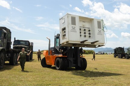 U.S. Marines with Marine Aviation Logistics Squadron (MALS) 24, Marine Aircraft Group 24,1st Marine Aircraft Wing, stage mobile maintenance facilities (MMFs) at Marine Corps Base Hawaii, April 15, 2024. The purpose of MALS-24's Displaced Warrior exercise is to demonstrate their ability to set up MMFs, assist flight operations and deliver supply support in an austere environment. (U.S. Marine Corps photo by Lance Cpl. Tania Guerrero)