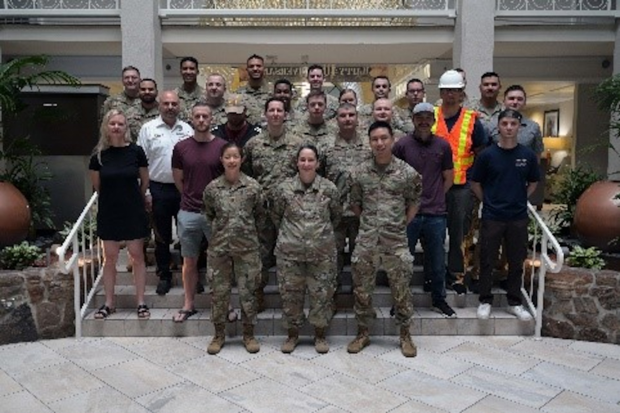 Group of people posing for a photo on stairs.
