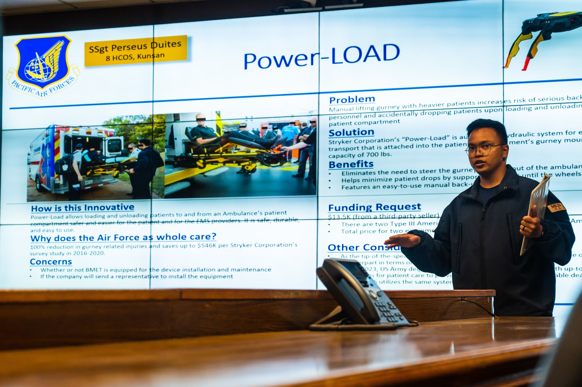 Staff Sgt. Perseus Duites, 8th Healthcare Operations Squadron paramedic, presents an innovative power load idea to Col. Matthew Gaetke, 8th Fighter Wing commander, during a Wolfwerx event.