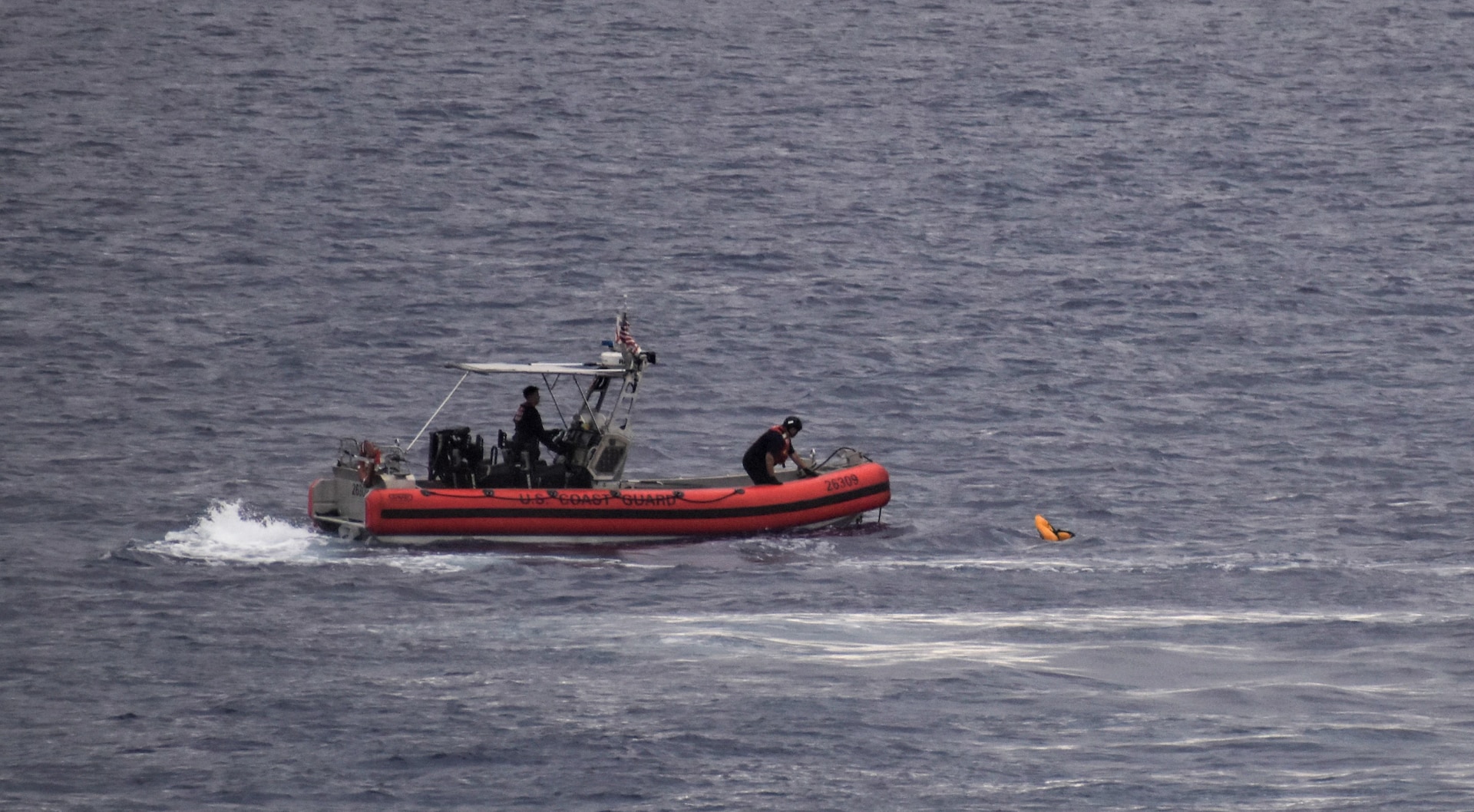 A USCGC Resolute small boat crew recovers a life jacket from the sunken 90-foot schooner De Gallant approximately 20 miles north of Great Inagua, May 21, 2024.