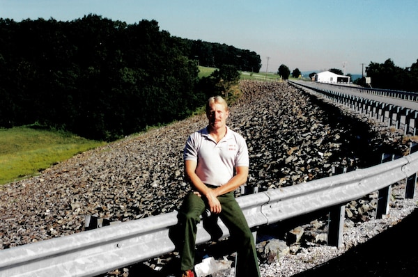Man sitting on guardrail