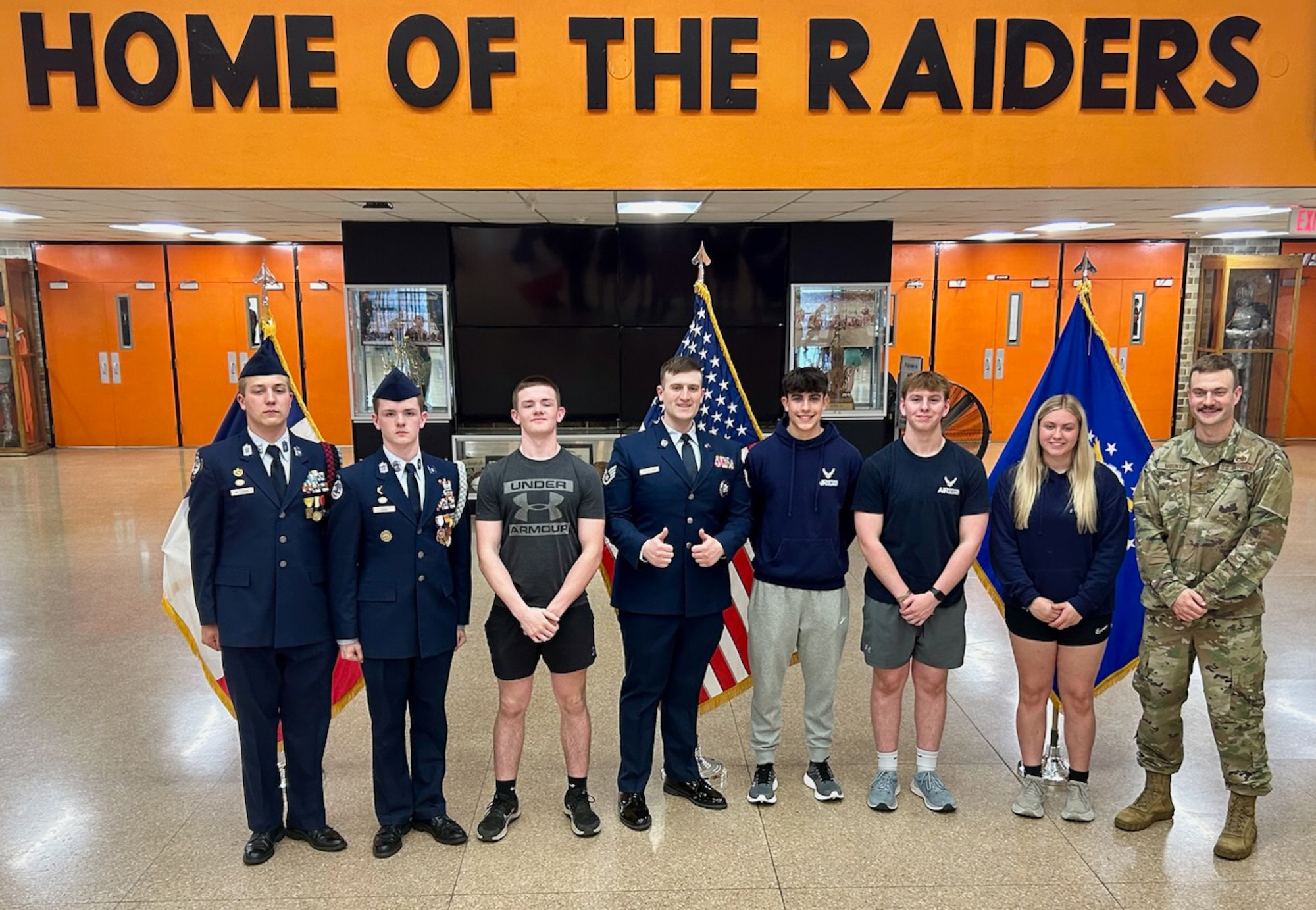 Brayden Cook, Joeseph Peterson, Tyler Cook, Tanner Sands, Noah Weakland, Kailynne Spates, U.S. Air National Guard Technical Sgt. Vincent Helgeson, a 185th Air Refueling Wing production recruiter, and 2nd Lieutenant Wyatt Mounts, a 185th ARW Maintenance Officer, pose for a photo