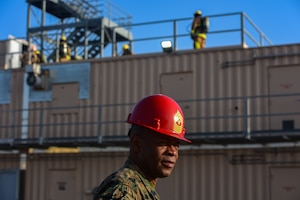 U.S. Marine Corps Master Gunnery Sgt. Terrail Dickerson, Marine Corps Detachment Goodfellow Air Force Base Fire Company senior enlisted advisor, walks the training pad at the Louis F. Garland Department of Defense Fire Academy on Goodfellow AFB, Texas, May 8, 2024. As the SEA, Dickerson has had a direct influence on the training and lives of individual Marines. (U.S. Marine Corps photo by Cpl. Jessica Roeder)