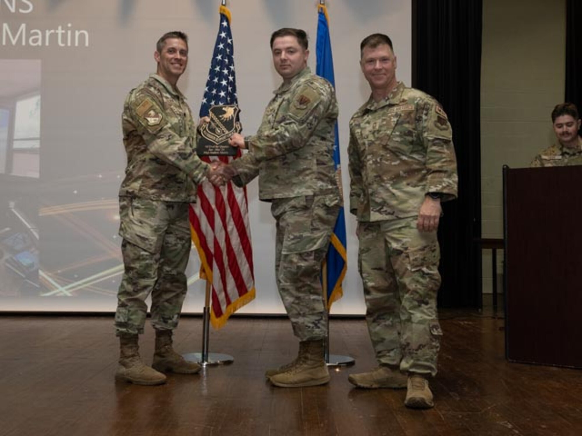 U.S. Air Force Lt. Col. James Melvin, left, Mission Support Group deputy commander, and Chief Master Sgt. Edward Mueller, right, Mission Support Group senior enlisted leader, presents Staff Sgt. Andrew Martin, center, contracting officer, with the Noncommissioned Officer of the First Quarter Award at Seymour Johnson Air Force Base, North Carolina, April 19, 2024. The ceremony recognized 10 individual award winners and one team for outstanding performance. (U.S. Air Force photo by Airman Megan Cusmano)