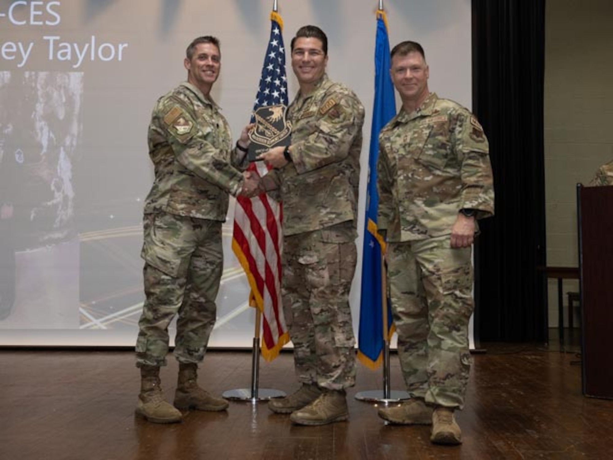 U.S. Air Force Lt. Col. James Melvin, left, Mission Support Group deputy commander, and Chief Master Sgt. Edward Mueller, right, Mission Support Group senior enlisted leader, Master Sgt. Bradley Taylor, center, section chief of explosive ordnance disposal logistics and supply with the Senior Noncommissioned Officer of the First Quarter Award at Seymour Johnson Air Force Base, North Carolina, April 19, 2024. The ceremony recognized the award winners for their exceptional leadership during the first quarter. (U.S. Air Force photo by Airman Megan Cusmano)