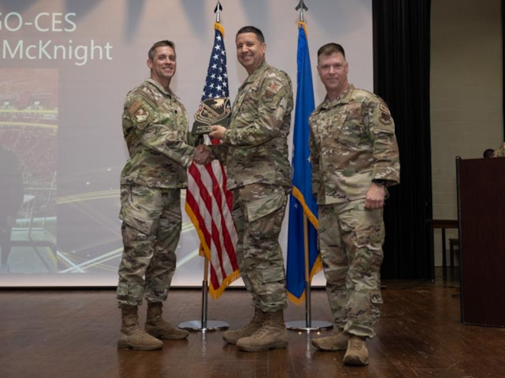 U.S. Air Force Lt. Col. James Melvin, left, Mission Support Group deputy commander, and Chief Master Sgt. Edward Mueller, right, Mission Support Group senior enlisted leader, Col. Hans Winkler, center,  who accepts the award on behalf of 1st Lt. Kenneth McKnight, officer in charge of program development, Junior Company Grade Officer of the First Quarter Award at Seymour Johnson Air Force Base, North Carolina, April 19, 2024. The ceremony recognized 10 individual award winners and one team for outstanding performance. (U.S. Air Force photo by Airman Megan Cusmano)