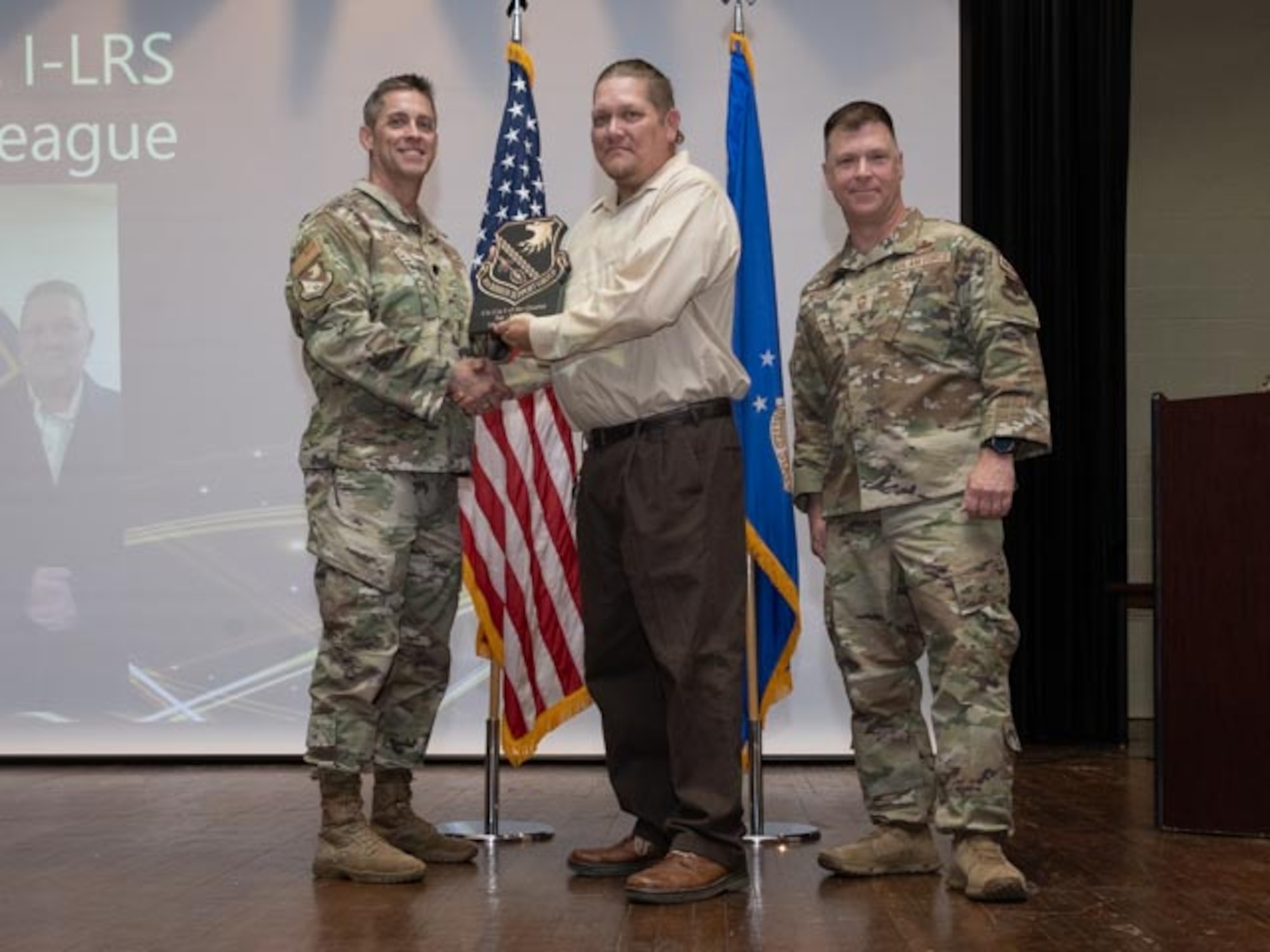 U.S. Air Force Lt. Col. James Melvin, left, Mission Support Group deputy commander, and Chief Master Sgt. Edward Mueller, right, Mission Support Group senior enlisted leader, presents Mr. Jason Teague, center, production controller, Civilian Category One of the First Quarter Award at Seymour Johnson Air Force Base, North Carolina, April 19, 2024.The ceremony recognized the award winners for their exceptional leadership during the first quarter. (U.S. Air Force photo by Airman Megan Cusmano)