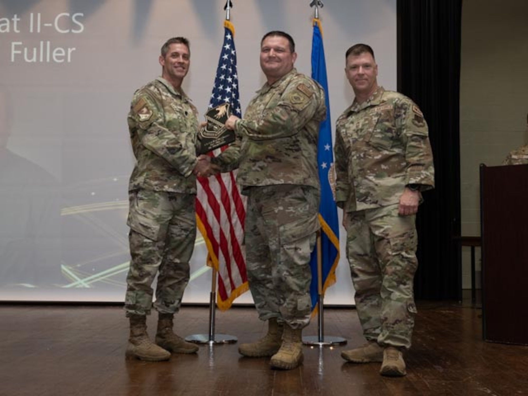 U.S. Air Force Lt. Col. James Melvin, left, Mission Support Group deputy commander, and Chief Master Sgt. Edward Mueller, right, Mission Support Group senior enlisted leader, Tech. Sgt. Robert Nobriga, center, who accepts the award on behalf of Mr. David Fuller, resource advisor, Civilian Category Two of the First Quarter Award at Seymour Johnson Air Force Base, North Carolina, April 19, 2024. The ceremony recognized 10 individual award winners and one team for outstanding performance. (U.S. Air Force photo by Airman Megan Cusmano
