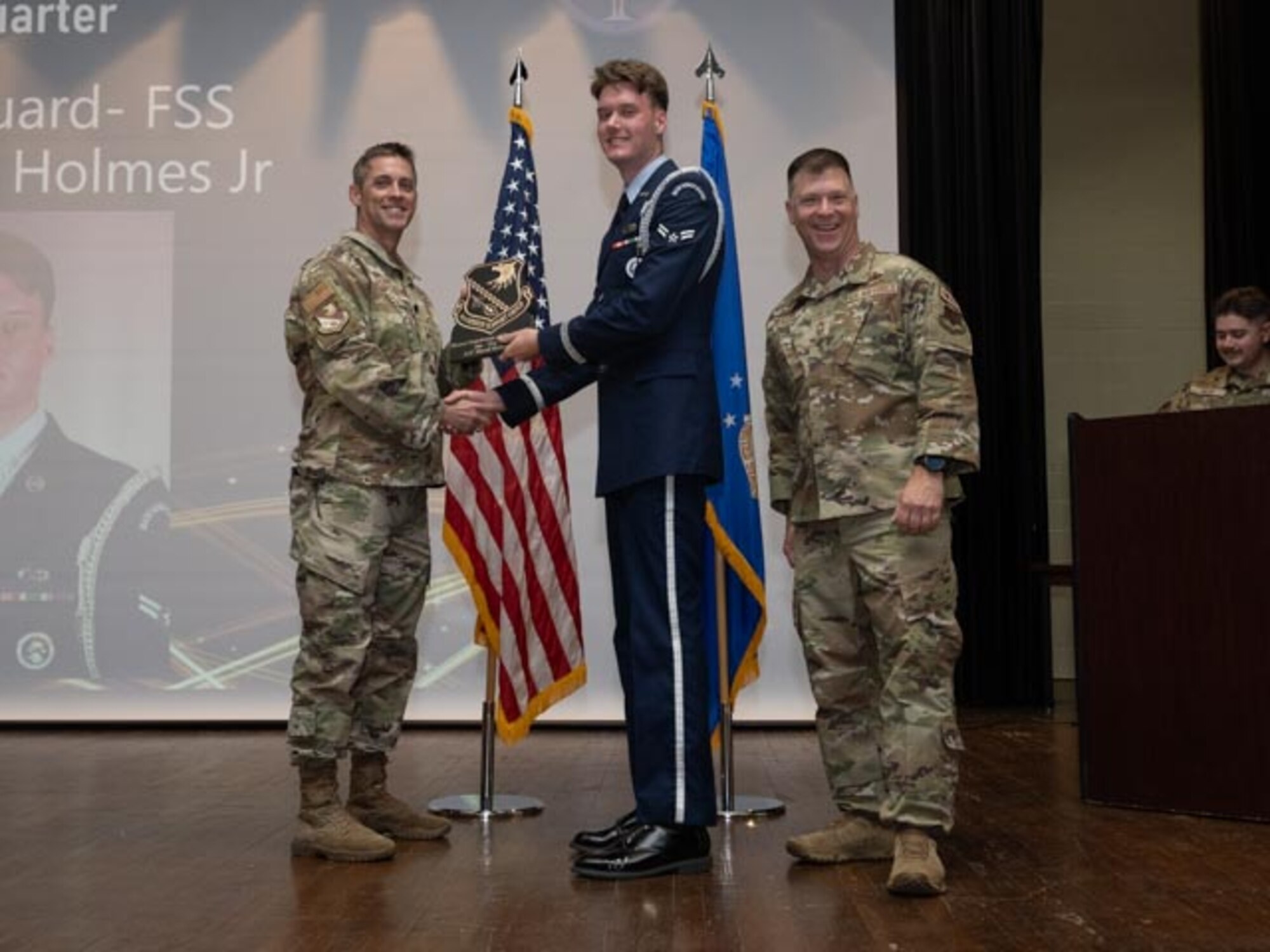 U.S. Air Force Lt. Col. James Melvin, left, Mission Support Group deputy commander, and Chief Master Sgt. Edward Mueller, right, Mission Support Group senior enlisted leader, presents Airman 1st Class David Holmes Jr., center, Honor Guard, Honor Guardsman of the First Quarter Award at Seymour Johnson Air Force Base, North Carolina, April 19, 2024. The ceremony recognized the award winners for their exceptional leadership during the first quarter. (U.S. Air Force photo by Airman Megan Cusmano)