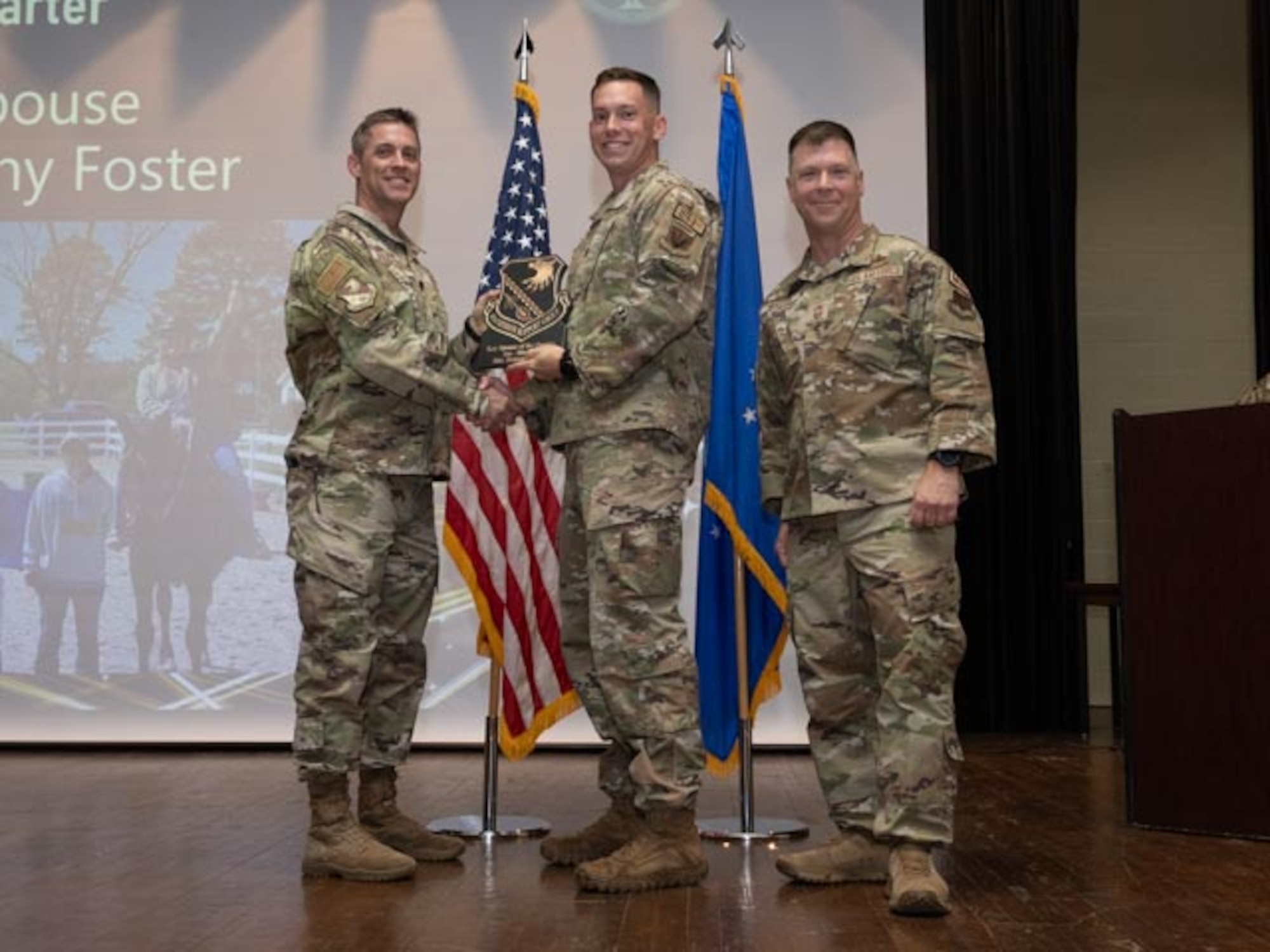U.S. Air Force Lt. Col. James Melvin, left, Mission Support Group deputy commander, and Chief Master Sgt. Edward Mueller, right, Mission Support Group senior enlisted leader, Capt. Benjamin Gardner, center, who accepts the award on behalf of Brittany Foster, Key Spouse of the First Quarter Award at Seymour Johnson Air Force Base, North Carolina, April 19, 2024. The ceremony recognized 10 individual award winners and one team for outstanding performance. (U.S. Air Force photo by Airman Megan Cusmano)