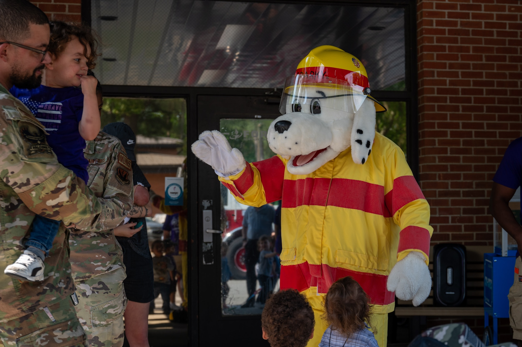 Sparky the dog, a fire protection mascot assigned to the 4th Civil Engineer Squadron, participates in the annual “Purple Up Parade” at Seymour Johnson Air Force Base, North Carolina, April 19, 2024. The parade recognized the resilience and strength of military children. (U.S. Air Force Photo by Airman Rebecca Tierney)