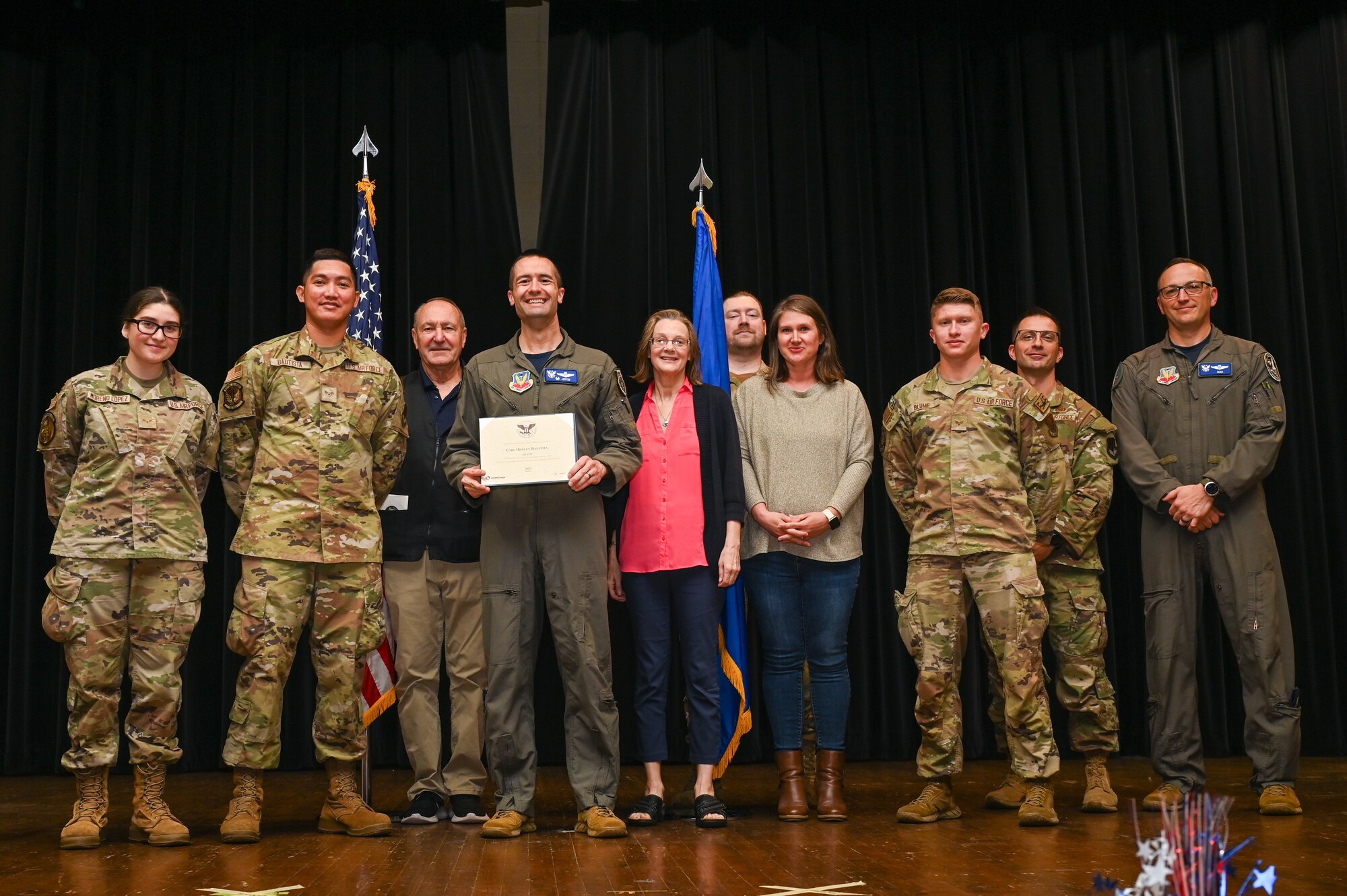 Col. Morgan Lohse, center, 4th Fighter Wing commander, and Col. Steven Bofferding, right, 4th Fighter Wing deputy commander, present the Silver Presidential Volunteer Service Award to Seymour Johnson Air Force Base volunteers during a volunteer appreciation ceremony at Seymour Johnson Air Force Base, North Carolina, April 26, 2024. The Silver award winners have completed 175 to 249 hours for young adults, 250 to 499 hours for adults and 500 to 999 for families and groups. (U.S. Air Force photo by Airman Rebecca Tierney)