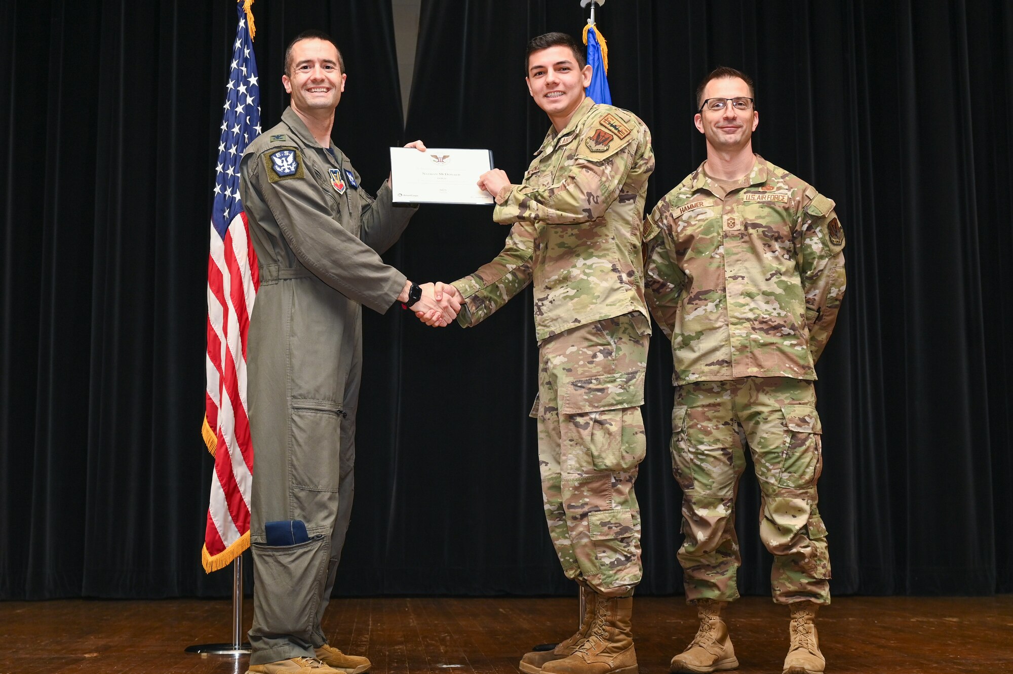Col. Morgan Lohse, left, 4th Fighter Wing commander, and Chief Master Sgt. Paul Hammer, right, 4th Fighter Wing command chief, present the Gold Presidential Volunteer Service Award to a Seymour Johnson Air Force Base volunteer during a volunteer appreciation ceremony at Seymour Johnson Air Force Base, North Carolina, April 26, 2024. The Gold award winners have completed 250 or more hours for young adults, 500 or more hours for adults and 1,000 or more for families and groups. (U.S. Air Force photo by Airman Rebecca Tierney)