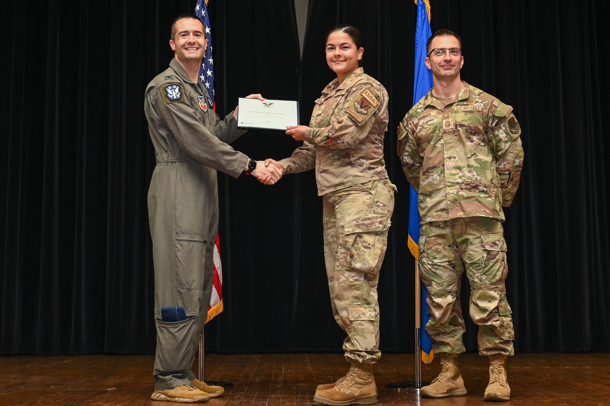 Col. Morgan Lohse, left, 4th Fighter Wing commander, and Chief Master Sgt. Paul Hammer, right, 4th Fighter Wing command chief, present the Gold Presidential Volunteer Service Award to a Seymour Johnson Air Force Base volunteer during a volunteer appreciation ceremony at Seymour Johnson Air Force Base, North Carolina, April 26, 2024. The Gold award winners have completed 250 or more hours for young adults, 500 or more hours for adults and 1,000 or more for families and groups. (U.S. Air Force photo by Airman Rebecca Tierney)