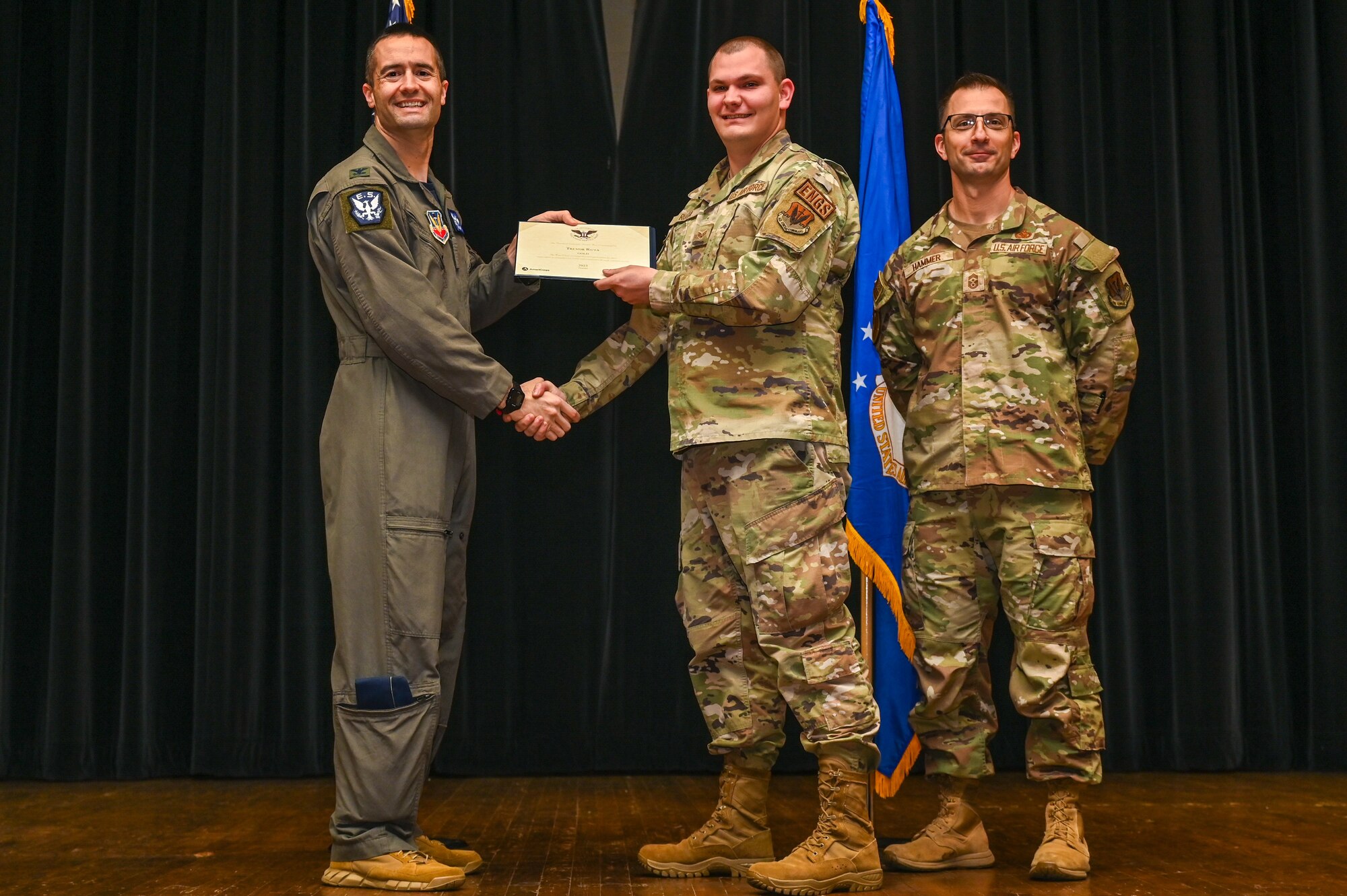 Col. Morgan Lohse, left, 4th Fighter Wing commander, and Chief Master Sgt. Paul Hammer, right, 4th Fighter Wing command chief, present the Gold Presidential Volunteer Service Award to a Seymour Johnson Air Force Base volunteer during a volunteer appreciation ceremony at Seymour Johnson Air Force Base, North Carolina, April 26, 2024. The Gold award winners have completed 250 or more hours for young adults, 500 or more hours for adults and 1,000 or more for families and groups. (U.S. Air Force photo by Airman Rebecca Tierney)