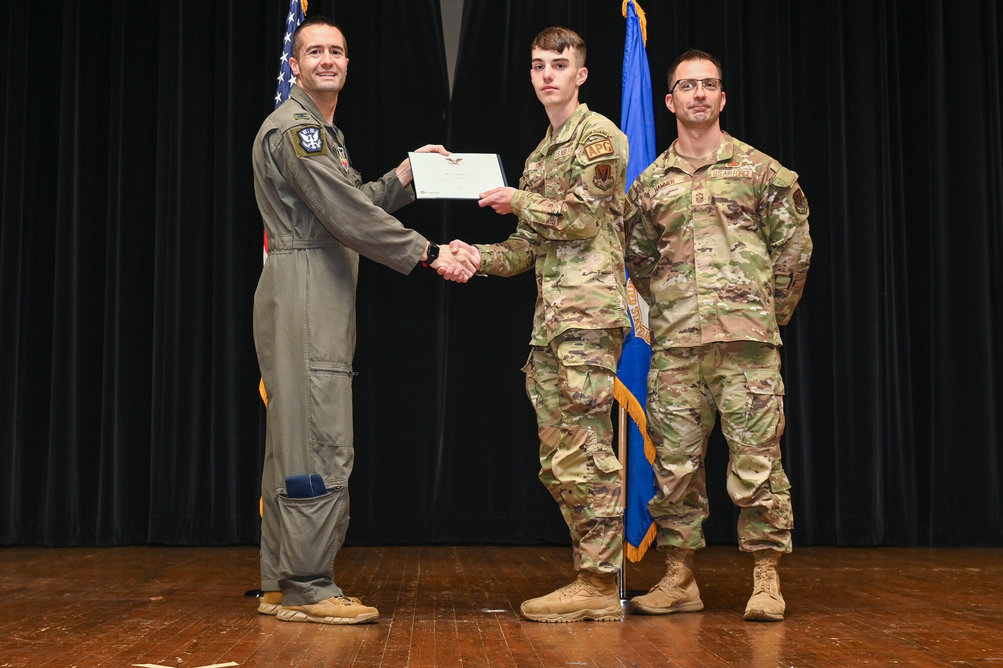 Col. Morgan Lohse, left, 4th Fighter Wing commander, and Chief Master Sgt. Paul Hammer, right, 4th Fighter Wing command chief, present the Gold Presidential Volunteer Service Award to a Seymour Johnson Air Force Base volunteer during a volunteer appreciation ceremony at Seymour Johnson Air Force Base, North Carolina, April 26, 2024. The Gold award winners have completed 250 or more hours for young adults, 500 or more hours for adults and 1,000 or more for families and groups. (U.S. Air Force photo by Airman Rebecca Tierney)
