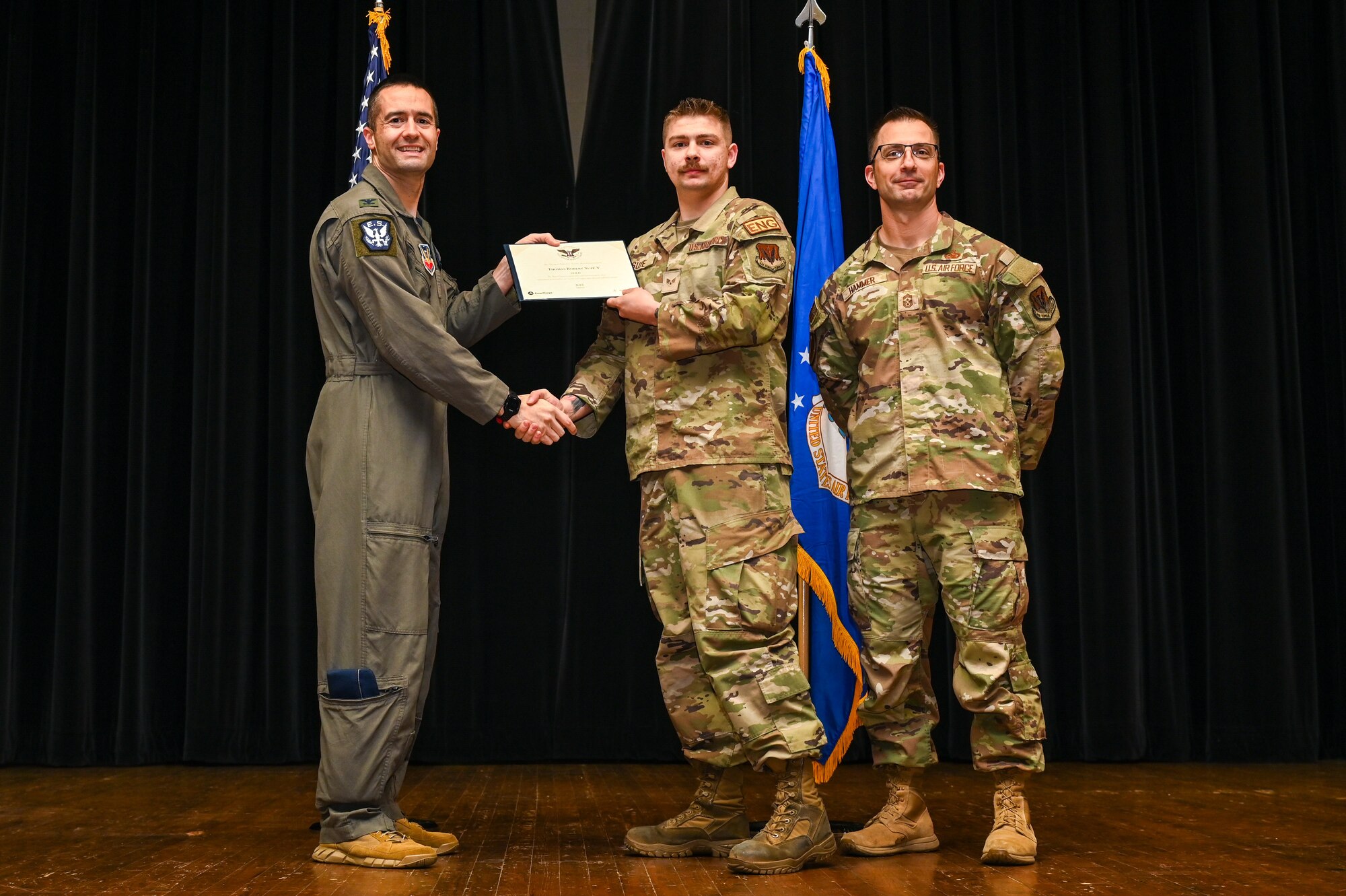 Col. Morgan Lohse, left, 4th Fighter Wing commander, and Chief Master Sgt. Paul Hammer, right, 4th Fighter Wing command chief, present the Gold Presidential Volunteer Service Award to a Seymour Johnson Air Force Base volunteer during a volunteer appreciation ceremony at Seymour Johnson Air Force Base, North Carolina, April 26, 2024. The Gold award winners have completed 250 or more hours for young adults, 500 or more hours for adults and 1,000 or more for families and groups. (U.S. Air Force photo by Airman Rebecca Tierney)