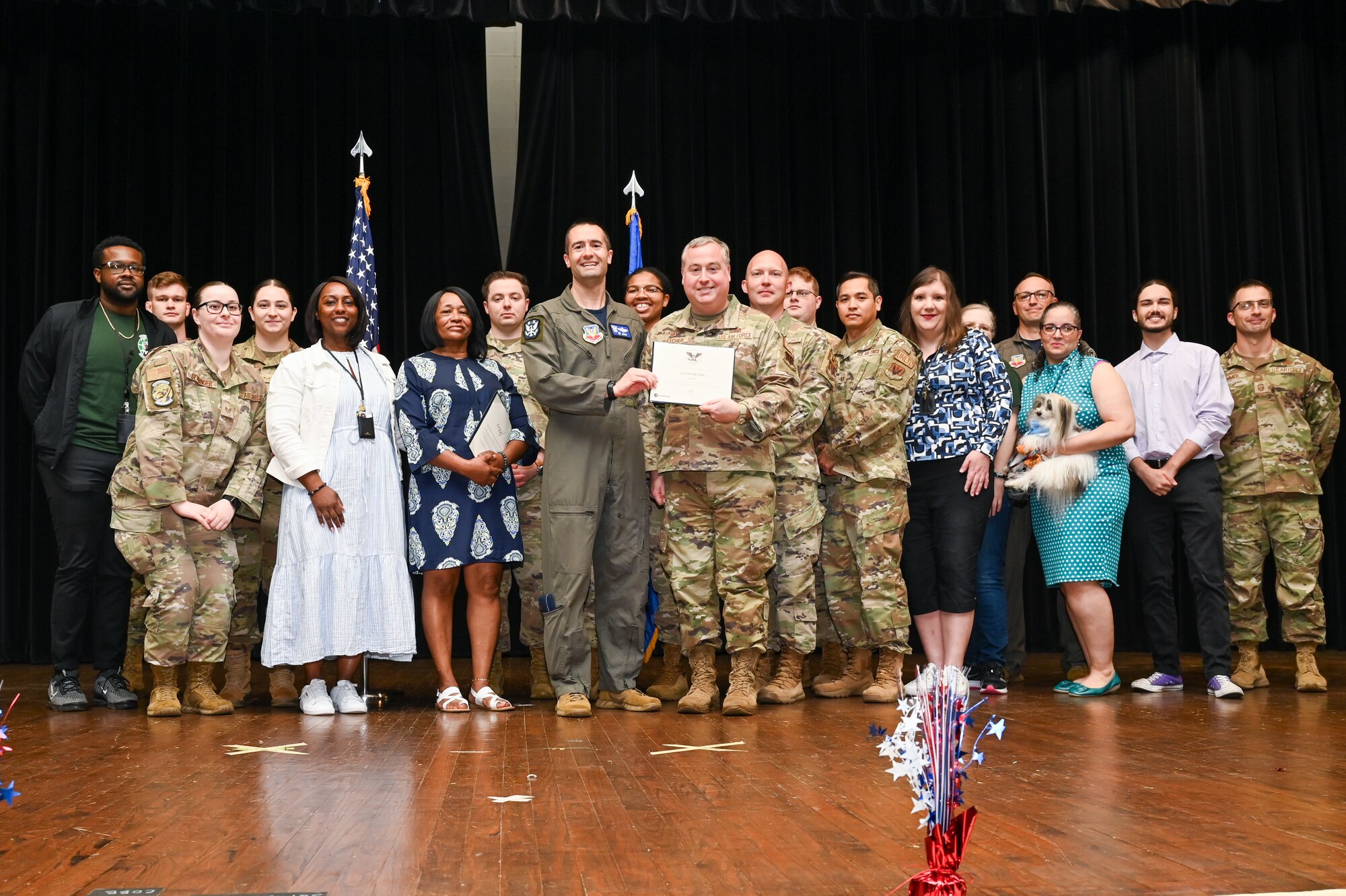 Col. Morgan Lohse, center, 4th Fighter Wing commander, and Chief Master Sgt. Paul Hammer, right, 4th Fighter Wing deputy commander, present the Gold Presidential Volunteer Service Award to Seymour Johnson Air Force Base volunteers during a volunteer appreciation ceremony at Seymour Johnson Air Force Base, North Carolina, April 26, 2024. The Gold award winners have completed 250 or more hours for young adults, 500 or more hours for adults and 1,000 or more for families and groups. (U.S. Air Force photo by Airman Rebecca Tierney)