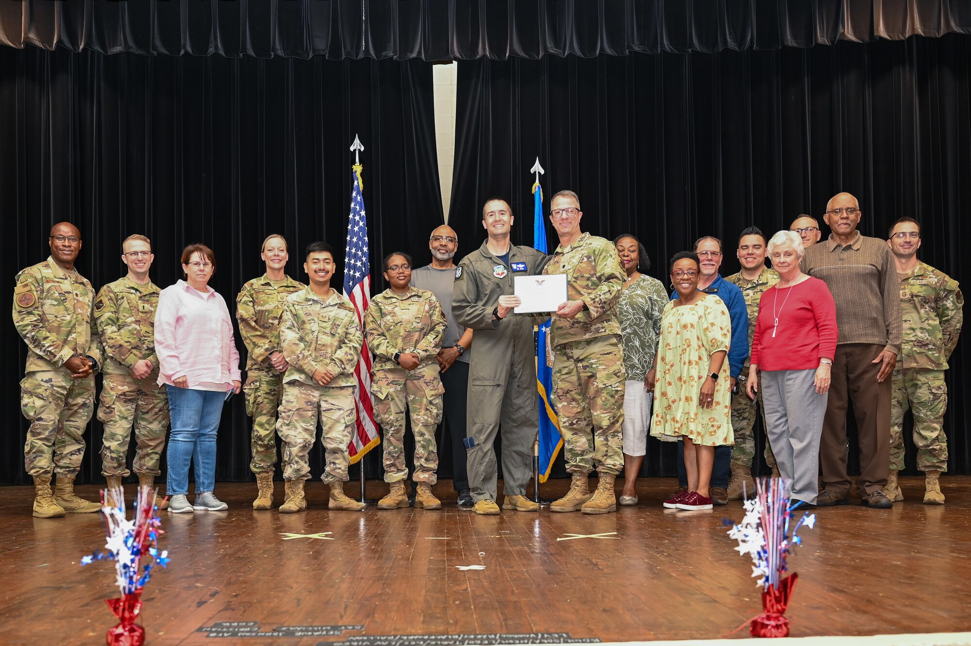 Col. Morgan Lohse, center, 4th Fighter Wing commander, and Chief Master Sgt. Paul Hammer, right, 4th Fighter Wing command chief, present the Gold Presidential Volunteer Service Award to Seymour Johnson Air Force Base volunteers during a volunteer appreciation ceremony at Seymour Johnson Air Force Base, North Carolina, April 26, 2024. The Gold award winners have completed 250 or more hours for young adults, 500 or more hours for adults and 1,000 or more for families and groups. (U.S. Air Force photo by Airman Rebecca Tierney)