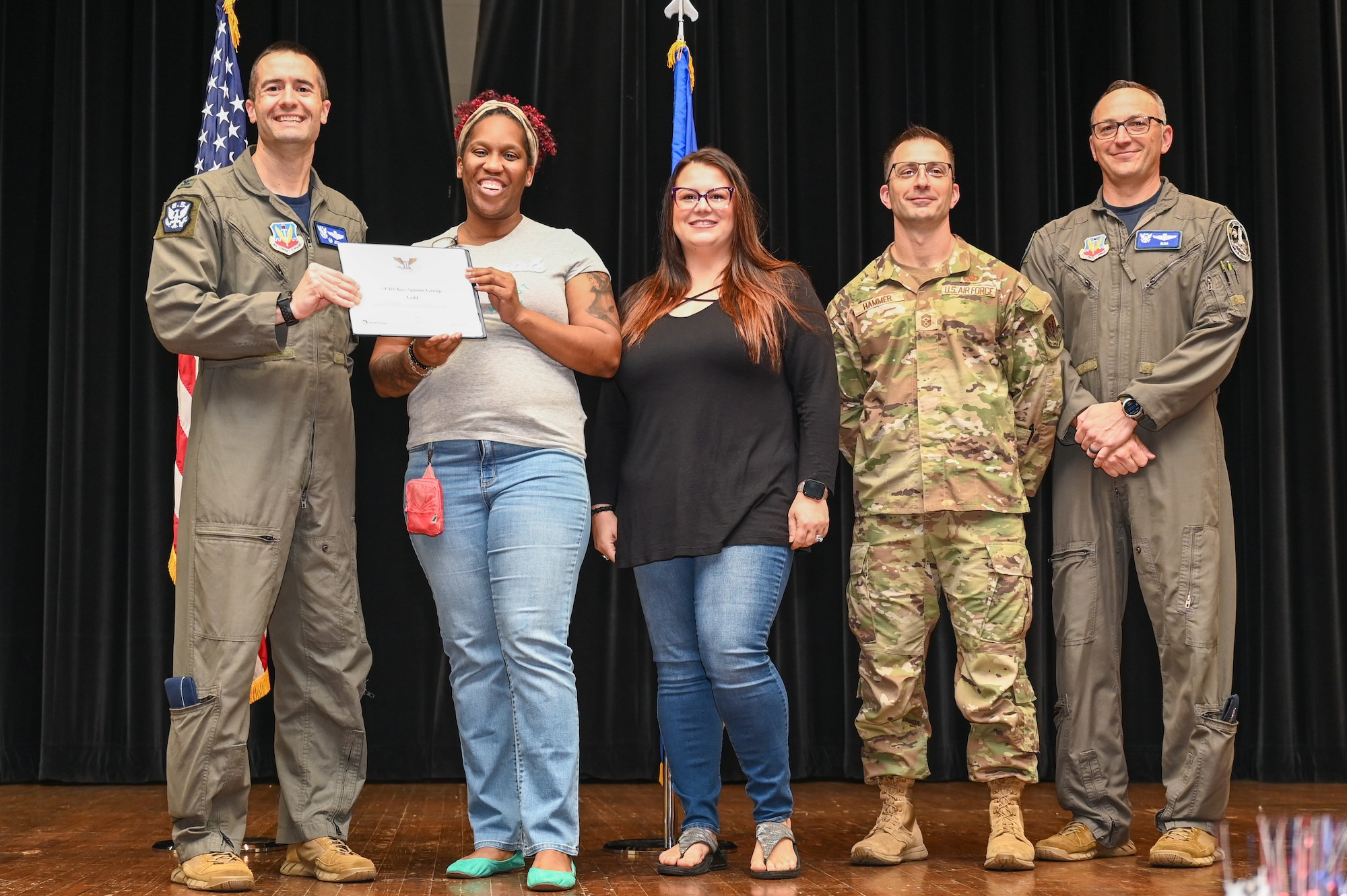 Col. Morgan Lohse, left, 4th Fighter Wing commander, and Col. Steven Bofferding, right, 4th Fighter Wing deputy commander, present the Gold Presidential Volunteer Service Award to Seymour Johnson Air Force Base volunteers during a volunteer appreciation ceremony at Seymour Johnson Air Force Base, North Carolina, April 26, 2024. The Gold award winners have completed 250 or more hours for young adults, 500 or more hours for adults and 1,000 or more for families and groups. (U.S. Air Force photo by Airman Rebecca Tierney)