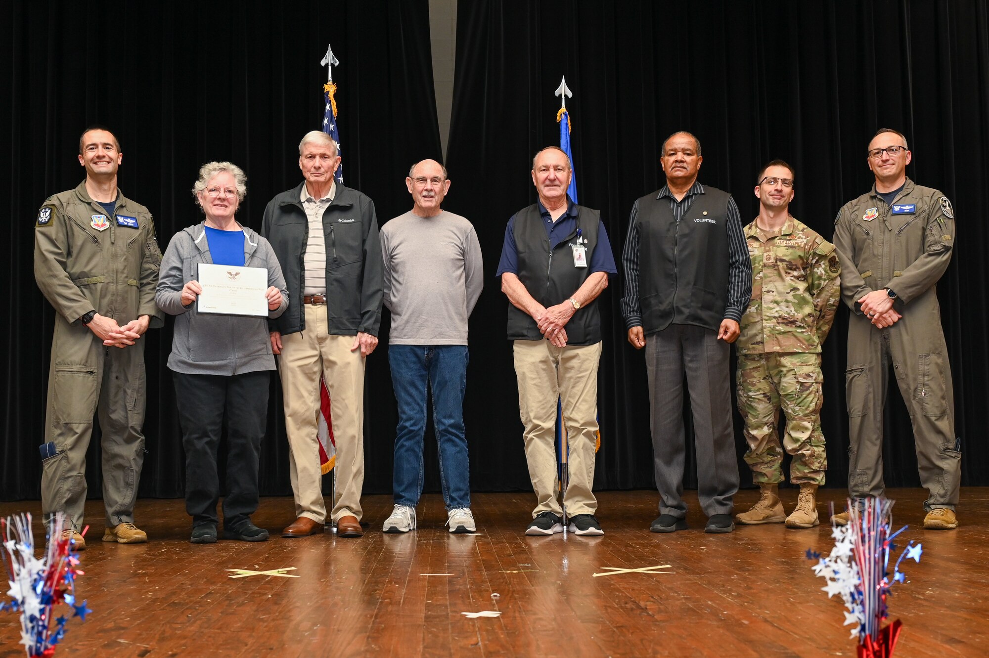 Col. Morgan Lohse, left, 4th Fighter Wing commander, and Col. Steven Bofferding, right, 4th Fighter Wing deputy commander, present the Gold Presidential Volunteer Service Award to Seymour Johnson Air Force Base volunteers during a volunteer appreciation ceremony at Seymour Johnson Air Force Base, North Carolina, April 26, 2024. The Gold award winners have completed 250 or more hours for young adults, 500 or more hours for adults and 1,000 or more for families and groups. (U.S. Air Force photo by Airman Rebecca Tierney)
