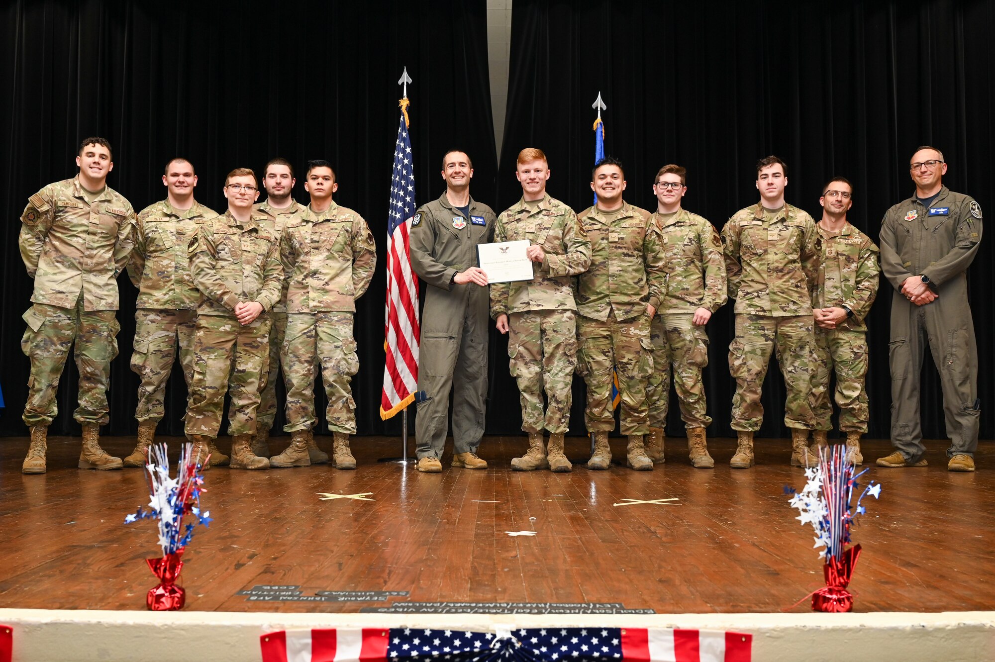 Col. Morgan Lohse, center left, 4th Fighter Wing commander, and Col. Steven Bofferding, right, 4th Fighter Wing deputy commander, present the Gold Presidential Volunteer Service Award to Seymour Johnson Air Force Base volunteers during a volunteer appreciation ceremony at Seymour Johnson Air Force Base, North Carolina, April 26, 2024. The Gold award winners have completed 250 or more hours for young adults, 500 or more hours for adults and 1,000 or more for families and groups. (U.S. Air Force photo by Airman Rebecca Tierney)