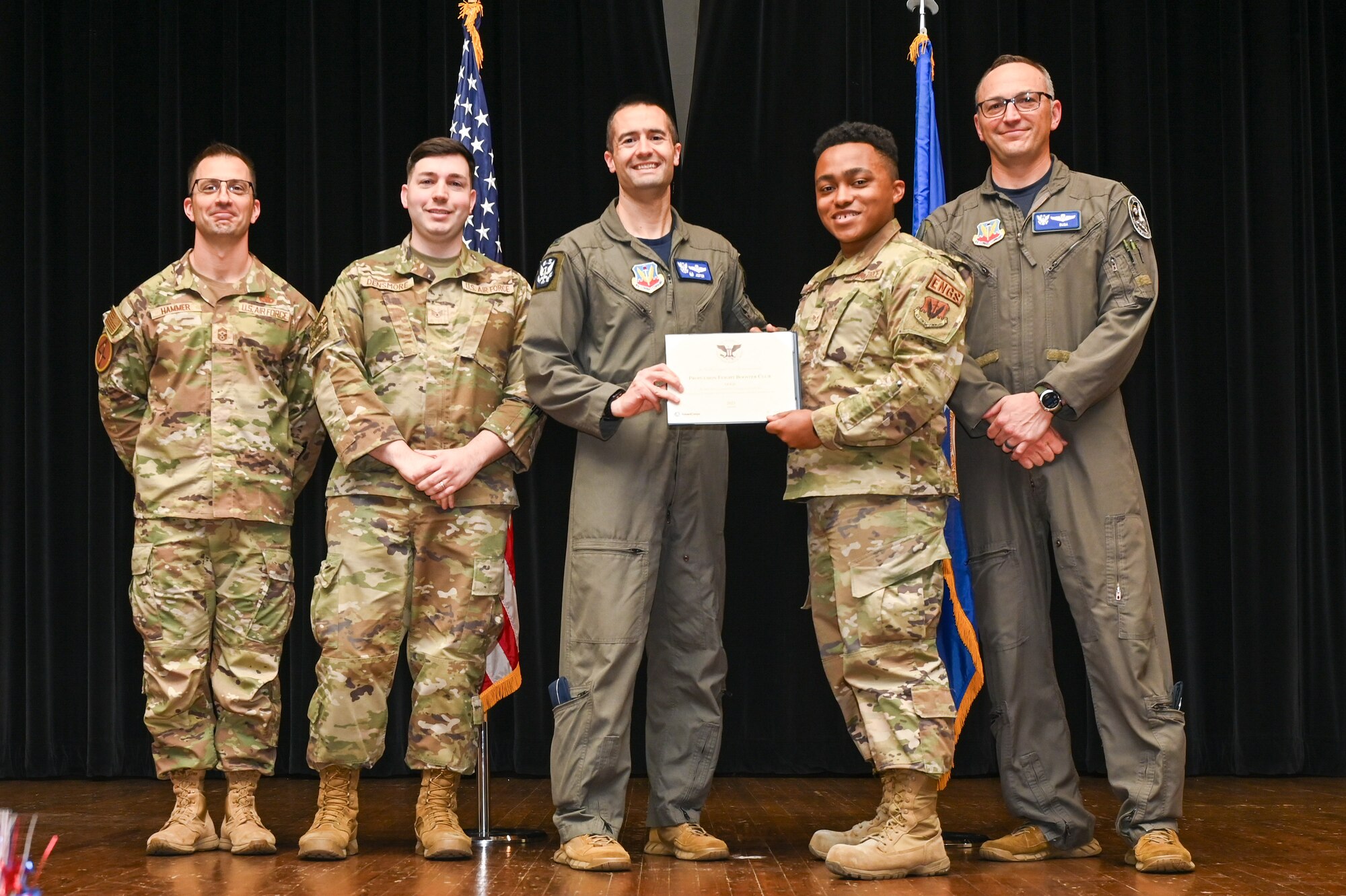 Col. Morgan Lohse, center, 4th Fighter Wing commander, and Col. Steven Bofferding, right, 4th Fighter Wing deputy commander, present the Gold Presidential Volunteer Service Award to Seymour Johnson Air Force Base volunteers during a volunteer appreciation ceremony at Seymour Johnson Air Force Base, North Carolina, April 26, 2024. The Gold award winners have completed 250 or more hours for young adults, 500 or more hours for adults and 1,000 or more for families and groups. (U.S. Air Force photo by Airman Rebecca Tierney)