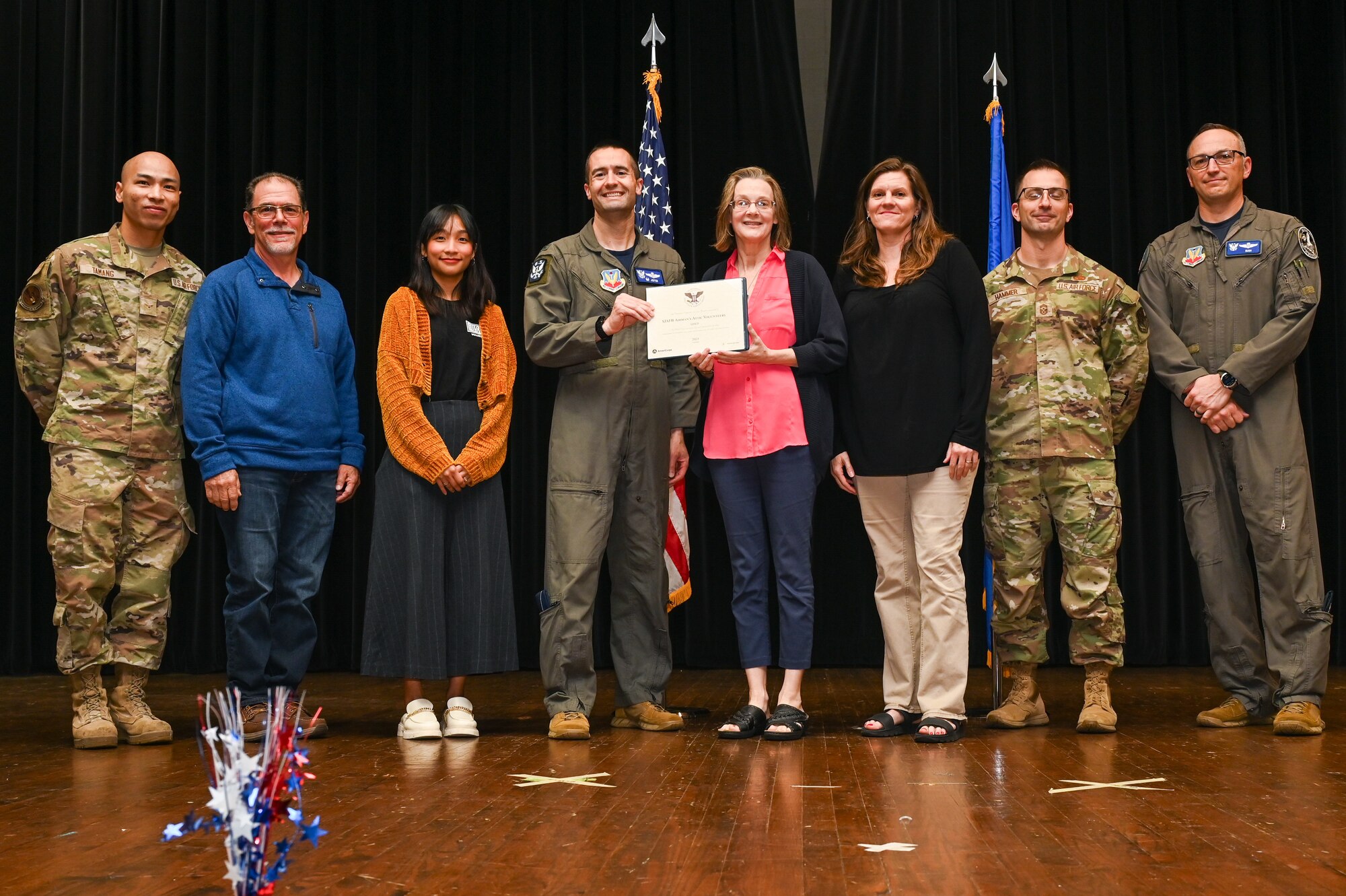 Col. Morgan Lohse, center left, 4th Fighter Wing commander, and Col. Steven Bofferding, right, 4th Fighter Wing deputy commander, present the Gold Presidential Volunteer Service Award to Seymour Johnson Air Force Base volunteers during a volunteer appreciation ceremony at Seymour Johnson Air Force Base, North Carolina, April 26, 2024. The Gold award winners have completed 250 or more hours for young adults, 500 or more hours for adults and 1,000 or more for families and groups. (U.S. Air Force photo by Airman Rebecca Tierney)