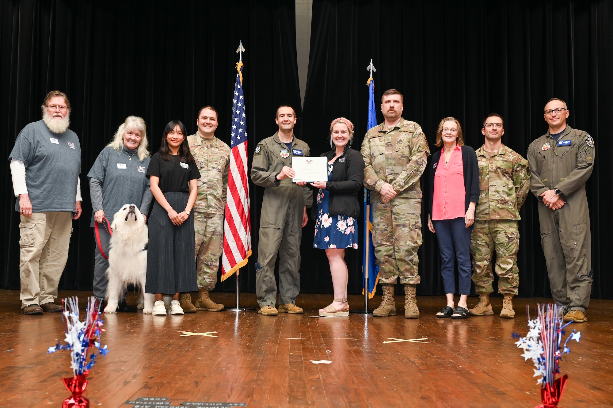 Col. Morgan Lohse, center left, 4th Fighter Wing commander, and Col. Steven Bofferding, right, 4th Fighter Wing deputy commander, present the Gold Presidential Volunteer Service Award to Seymour Johnson Air Force Base volunteers during a volunteer appreciation ceremony at Seymour Johnson Air Force Base, North Carolina, April 26, 2024. The Gold award winners have completed 250 or more hours for young adults, 500 or more hours for adults and 1,000 or more for families and groups. (U.S. Air Force photo by Airman Rebecca Tierney)