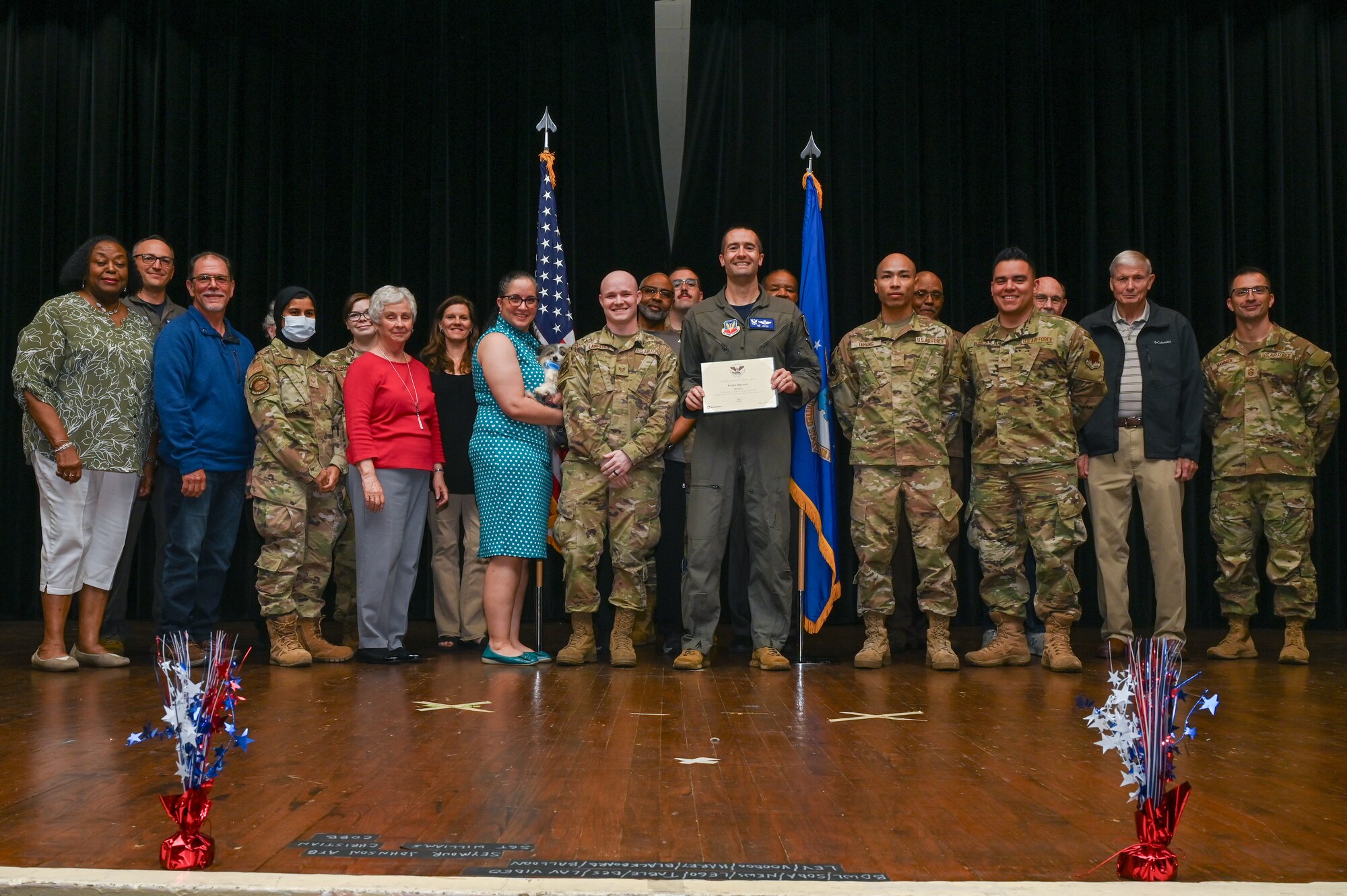 Col. Morgan Lohse, center, 4th Fighter Wing commander, and Chief Master Sgt. Paul Hammer, right, 4th Fighter Wing command chief, present the Bronze Presidential Volunteer Service Award to Seymour Johnson Air Force Base volunteers during a volunteer appreciation ceremony at Seymour Johnson Air Force Base, North Carolina, April 26, 2024. The Bronze award winners have completed 100 to 174 hours for young adults, 100 to 249 hours for adults and 200 to 499 for families and groups. (U.S. Air Force photo by Airman Rebecca Tierney)