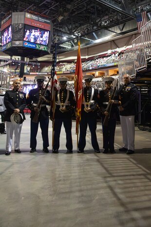 U.S. Marine Corps Maj. Kao Saeteurn, commanding officer of Recruiting Station Sacramento, left, Col. Michael Ogden, commanding officer of 12th Marine Corps District, right, and Marines with RS Sacramento Color Guard pose for a photograph during the 48th annual Chicano/Latino Commencement Celebration at California State University, Fresno, Calif., May 18, 2024. Chicanos and Latinos make up 58-percent of graduating students in the CSU system, many of them being first-generation students. (U.S. Marine Corps photo by Cpl. Bruin Largent)
