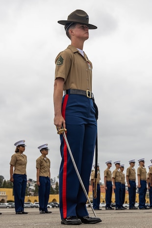 U.S. Marine Drill Instructor Staff Sgt. Haley Langille, 1st Recruit Training Battalion, present the guidons during a graduation ceremony at Marine Corps Recruit Depot San Diego, California, May 17, 2024. Graduation took place at the completion of the 13-week transformation, which included training for drill, marksmanship, basic combat skills, and Marine Corps customs and traditions. (U.S. Marine Corps photo by Cpl. Sarah M. Grawcock)