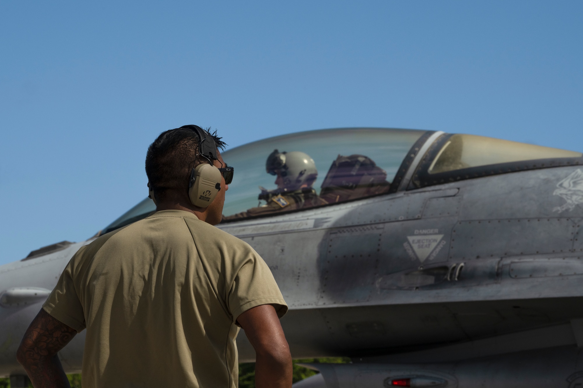 A crew chief prepares an aircraft for takeoff.