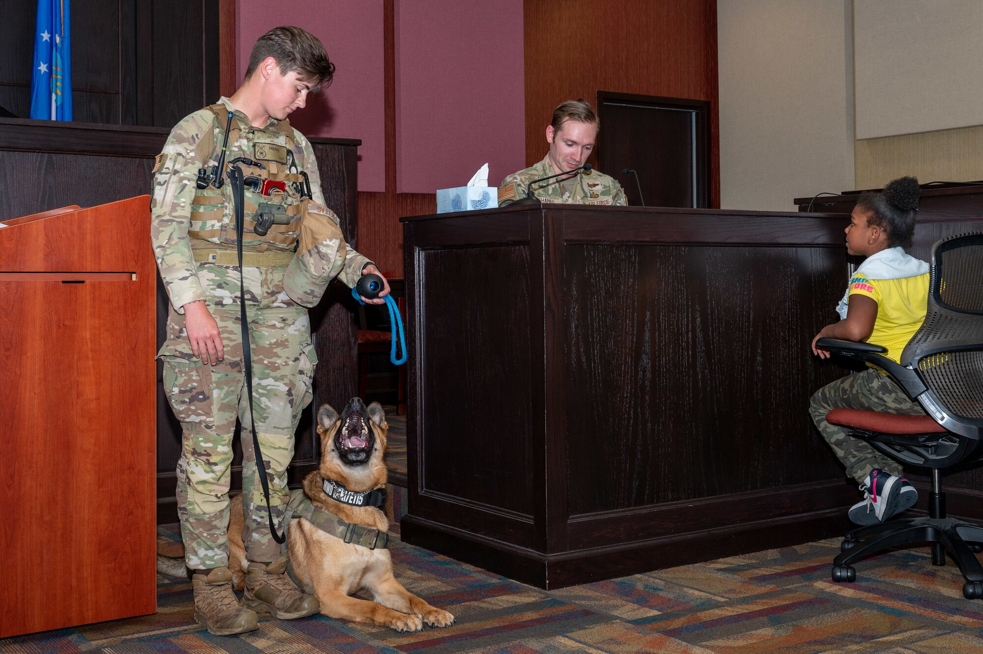 Children from the local community observe a canine demonstration during a mock trial at Seymour Johnson Air Force Base, North Carolina, May 2, 2024. The interactive trial followed a fictional case of stolen candy in which the children acted as the jury. (U.S. Air Force Photo by Airman Rebecca Tierney)