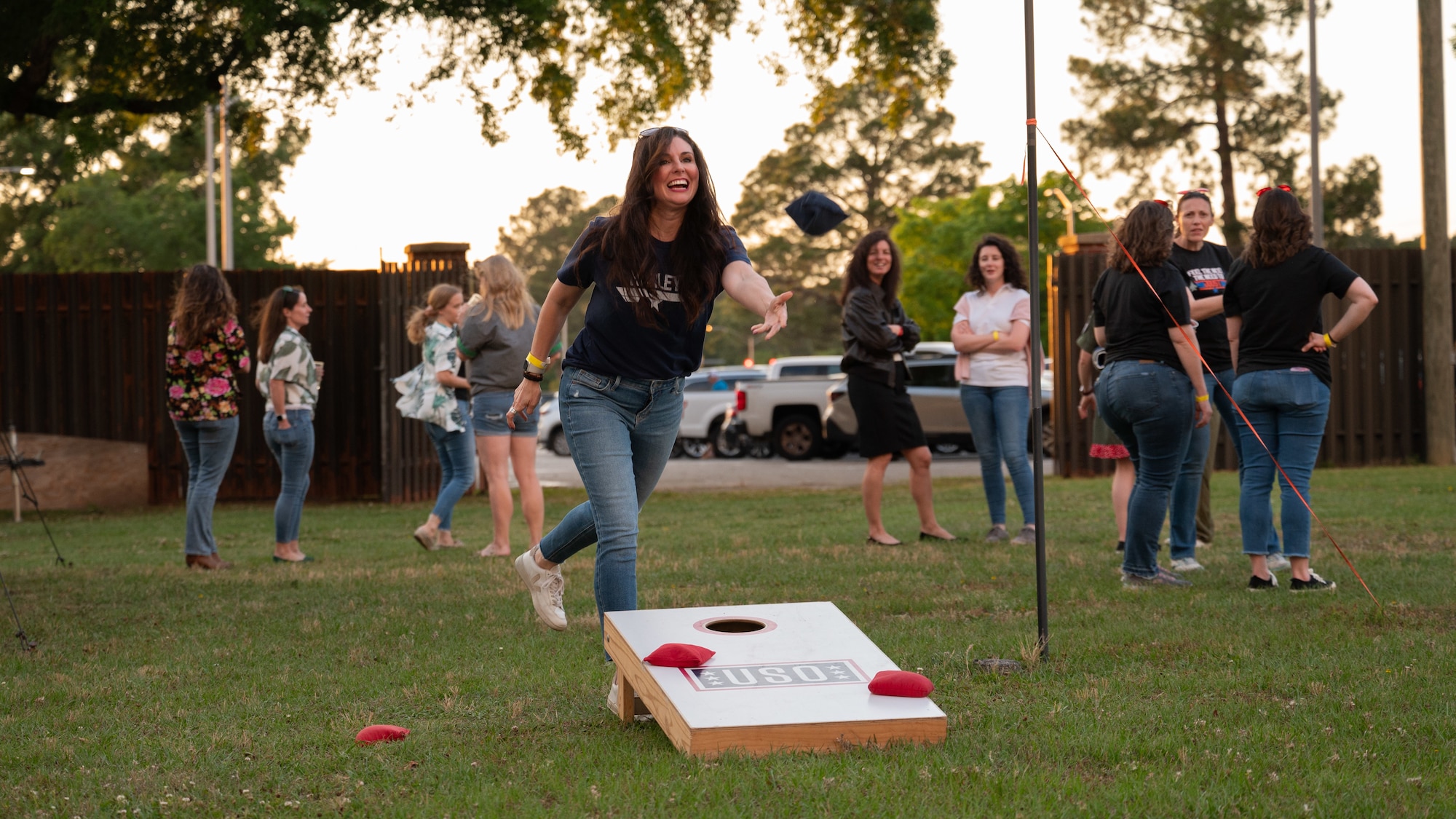 Military spouses enjoy a game of corn hole during a Spouse Appreciation Week dinner event at Seymour Johnson Air Force Base, North Carolina, May 10, 2024. The dinner was held in honor of Spouse Week, in which spouses are recognized and appreciated with different events on base. (U.S. Air Force Photo by Airman Rebecca Tierney)