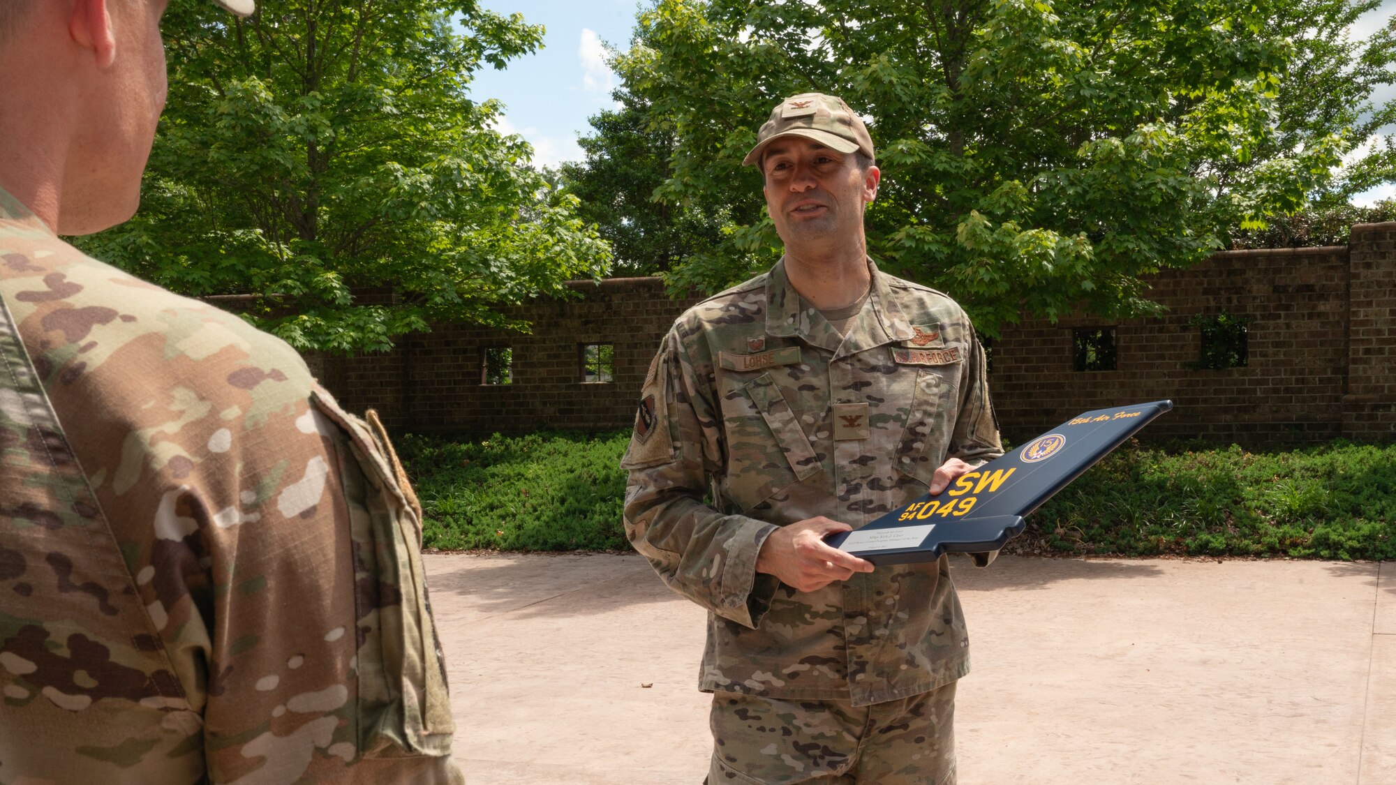 U.S. Air Force Col. Morgan Lohse, 4th Fighter Wing commander, presents the Honor Guard Program Manager of the Year Award to Master Sgt. Kyle Cisco, 4 FW Honor Guard program manager, at Seymour Johnson Air Force Base, North Carolina, May 16, 2024. The award recognizes the program manager who made the most impact on the base Honor Guard. (U.S. Air Force photo by Airman Rebecca Tierney)