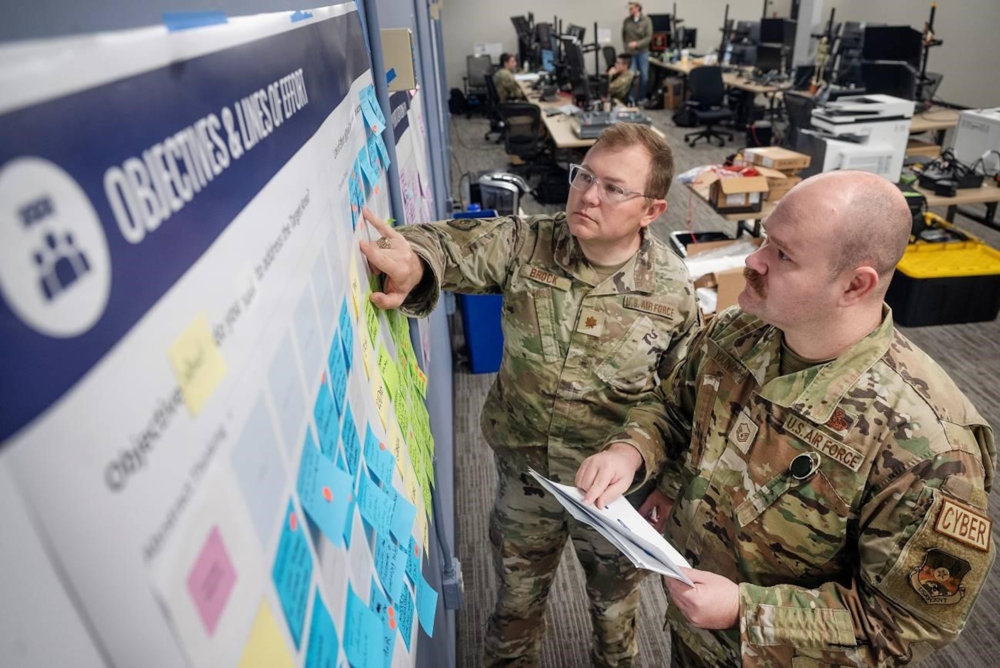 Lt. Col. Chaz LeDeatte, 9th Air Force (Air Forces Central) deputy chief of staff and chief technology and data officer, reviews notes and data on a digital transformation board alongside members of his Command Technology and Data Office (CTDO) team “Battle Lab” Mar. 19, 2024, at Shaw Air Force Base, S.C. The AFCENT ‘Battle Lab’ provides a space and capability where Airmen can innovate and cultivate ideas, and work with the CTDO to obtain resources to engineer, refine, and validate their requirements throughout the command. (U.S. Air Force photo )