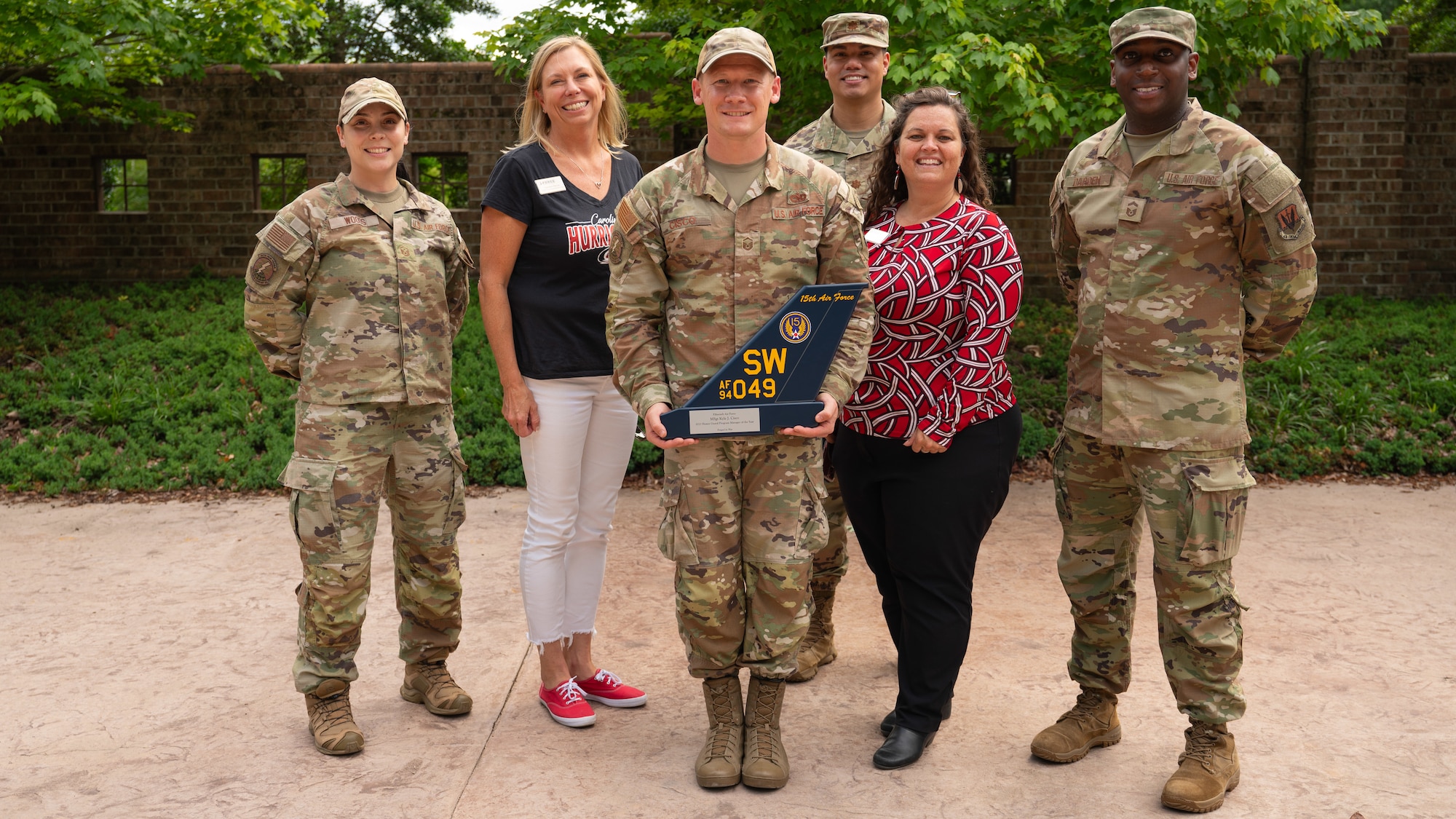 U.S. Air Force Master Sgt. Kyle Cisco, 4th Fighter Wing Honor Guard program manager, poses with his colleagues during a presentation of the Honor Guard Program Manager of the Year Award at Seymour Johnson Air Force Base, North Carolina, May 16, 2024. The annual award recognizes the program manager who made the most impact on the base Honor Guard. (U.S. Air Force photo by Airman Rebecca Tierney)