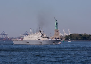 USS Marinette (LCS 25) sails past the Statue of Liberty.