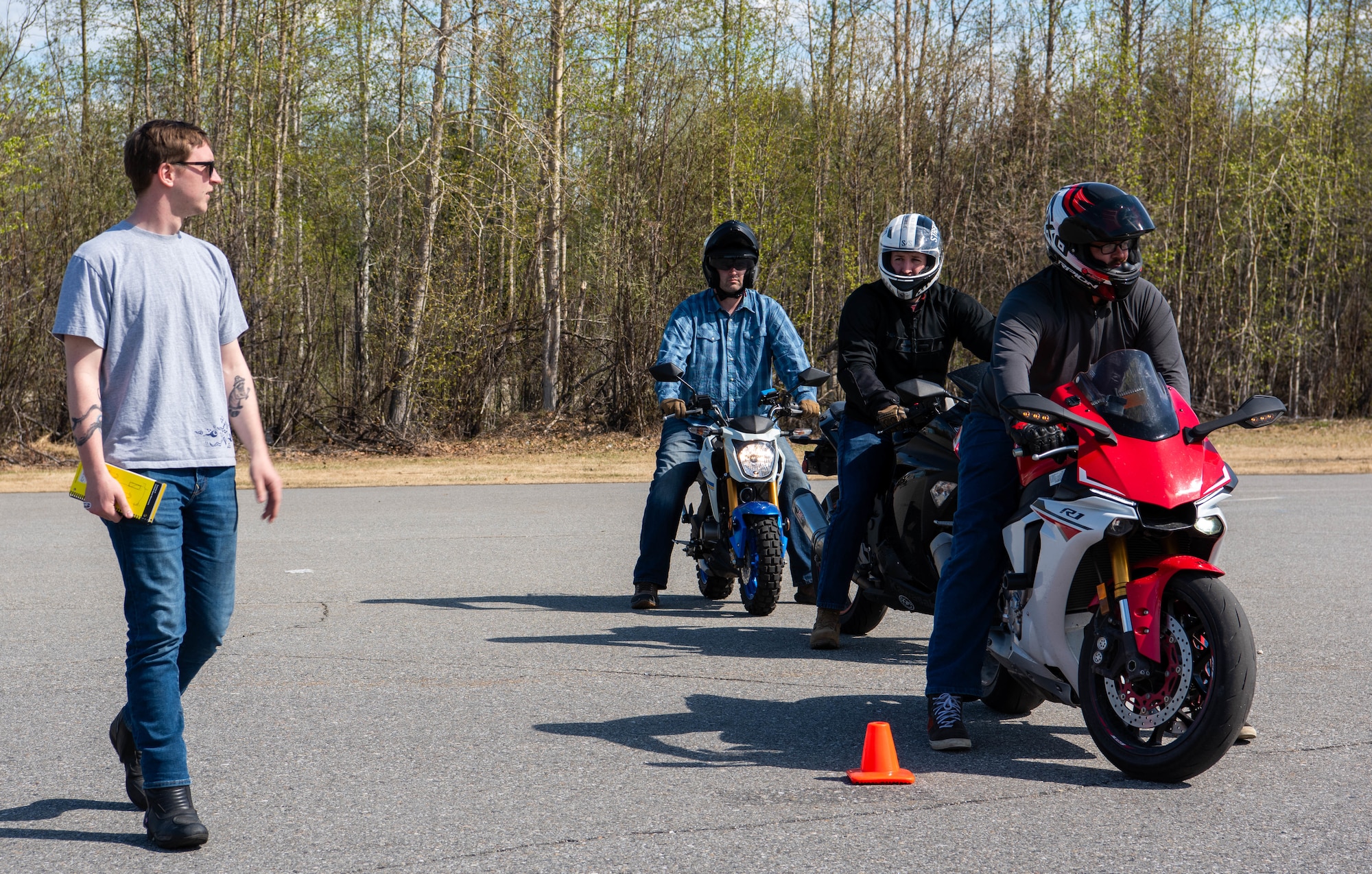 Airmen ride motorcycle on base.