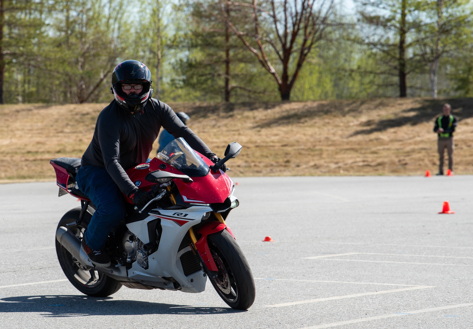 An Airman rides is motorcycle on base.