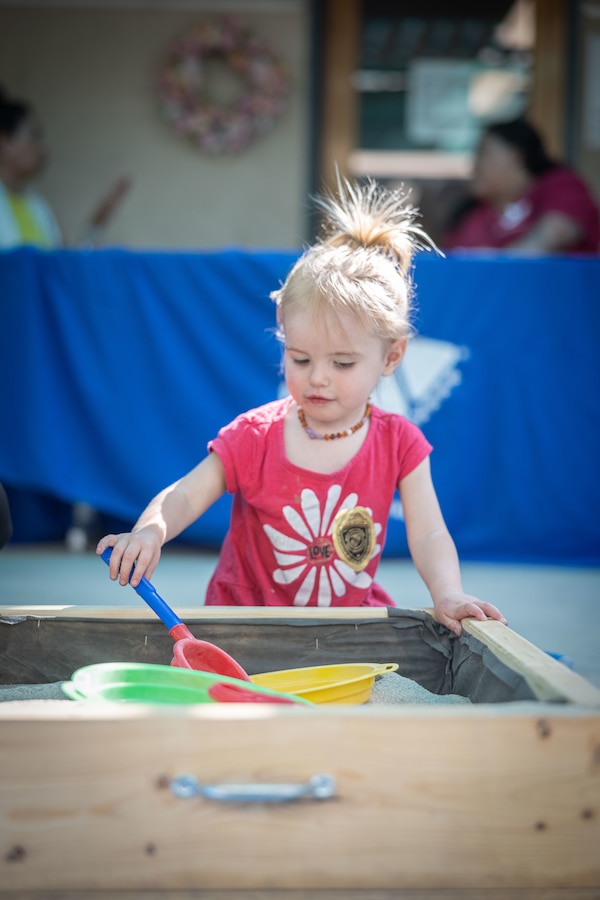 A child plays in the sandbox during the Kinder Round-Up event hosted by the Combat Center School Liaison at Marine Corps Air-Ground Combat Center, Twentynine Palms, California, May 15, 2024. The Kinder Round-Up event provides essential information and resources from local elementary schools to families with kindergarten-aged children. (U.S. Marine Corps photo by Cpl. Aidan Jones)